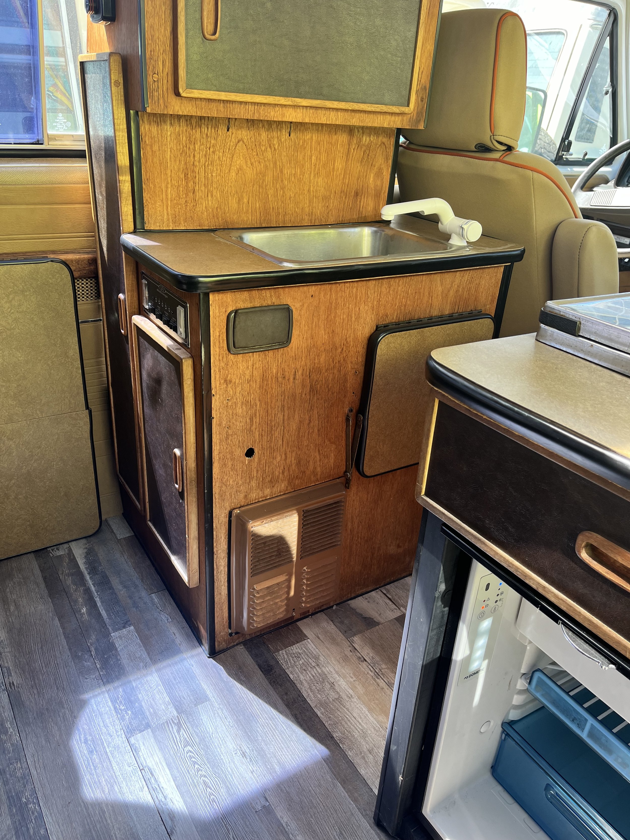 Kitchen galley w/sink, fridge, stove, storage