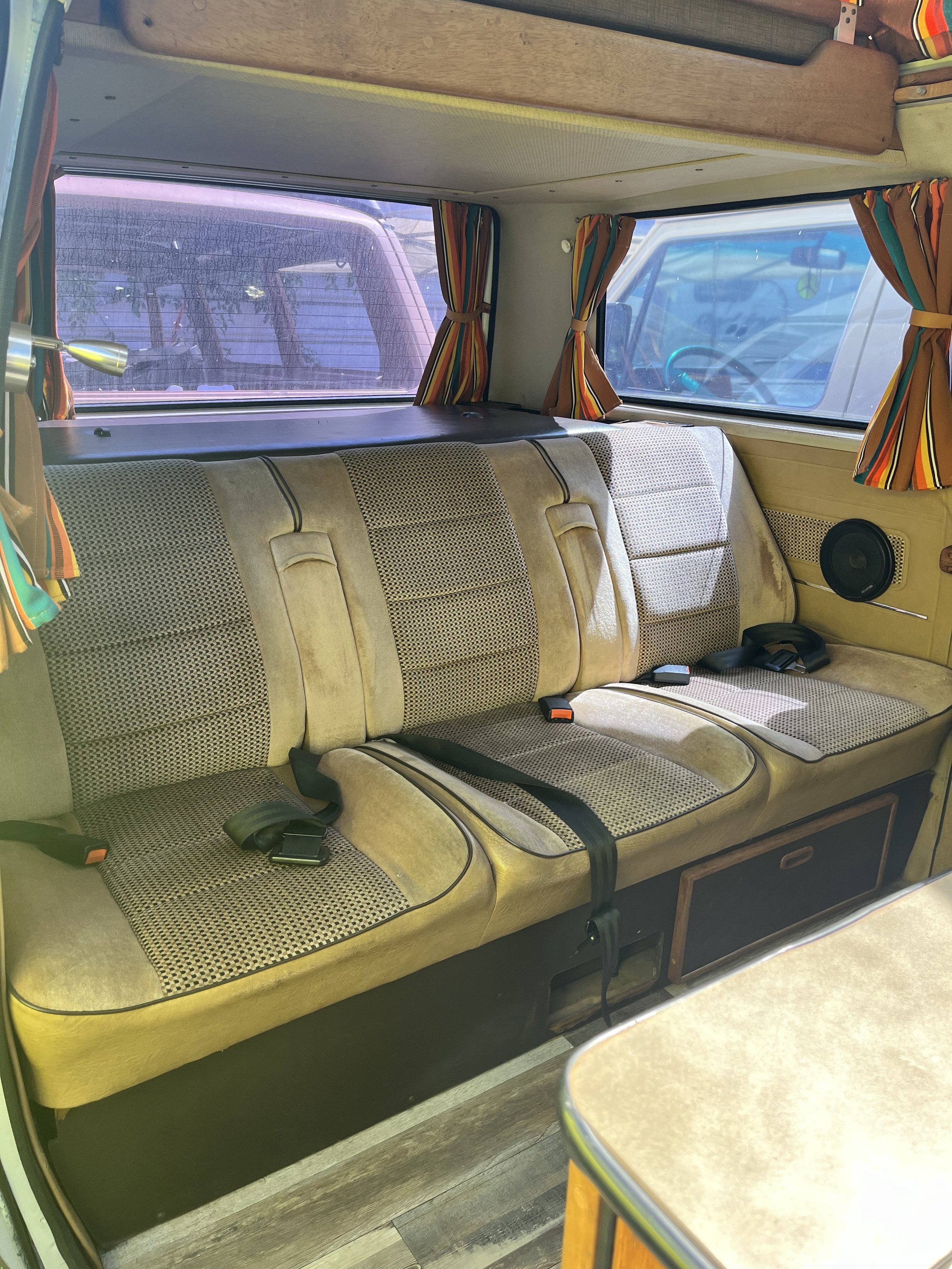 3 seats w/lap belts, folds down into a queen sized bed, storage underneath
