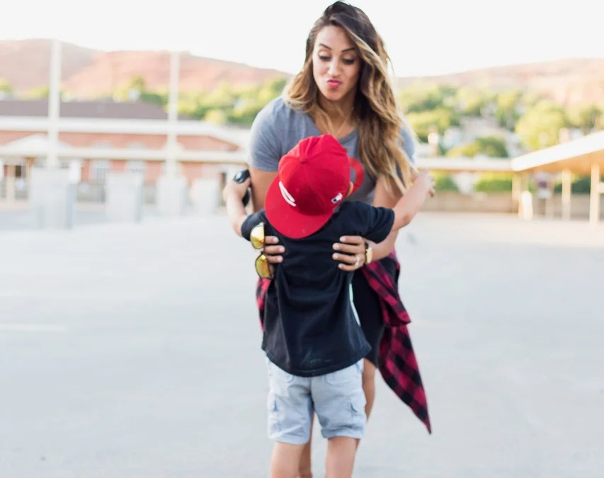 About Tia: I'm a total boy mama (3 and #4 on the way) and my Coach Andys #1 cheerleader. I own a non-profit dance studio The Vault where I teach dance and HOTMESS FITNESS classes. I love clothes a little too much and doing ANYTHING WITH FAMILY!! I'm a total homebody and a sucker for the sunset! I'm a dessert before dinner type of gal and I always order more than I can handle. My favorite color is “turqatoise” and my lucky number is….can't tell you.:)