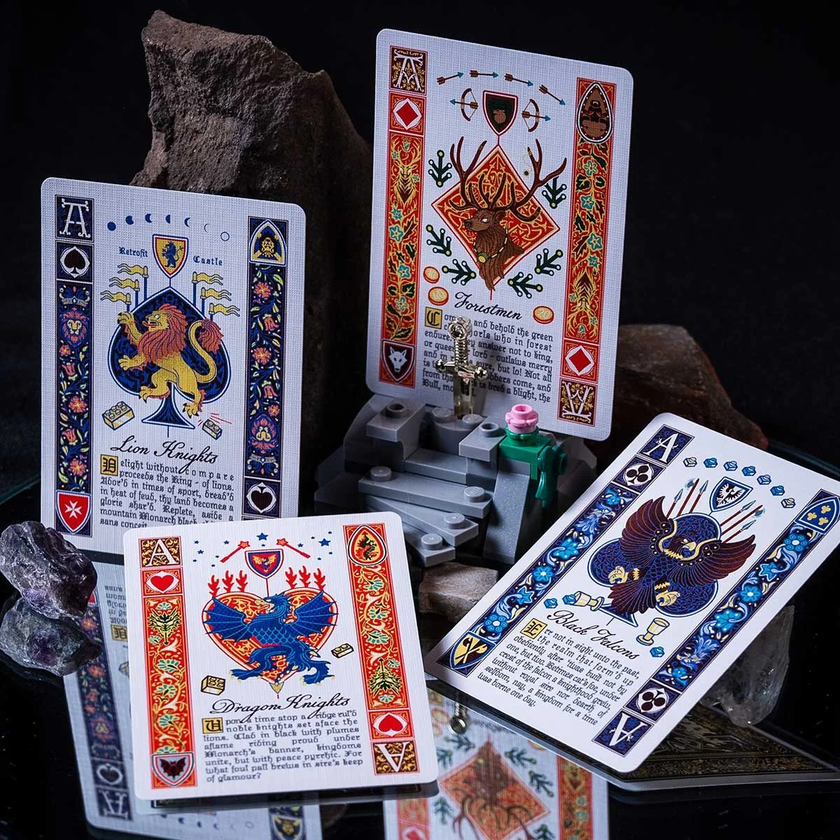 LEGO Castle ace playing cards lineup on a dark mirrored background with gemstones