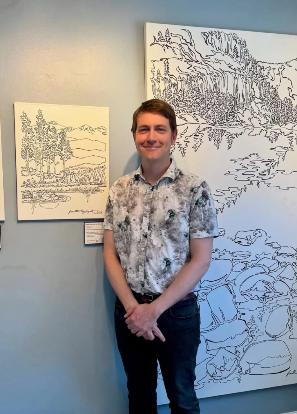 Jonathan Applegate infront of his painting at the Future Drawn oneLINE Gallery in Denver Colorado