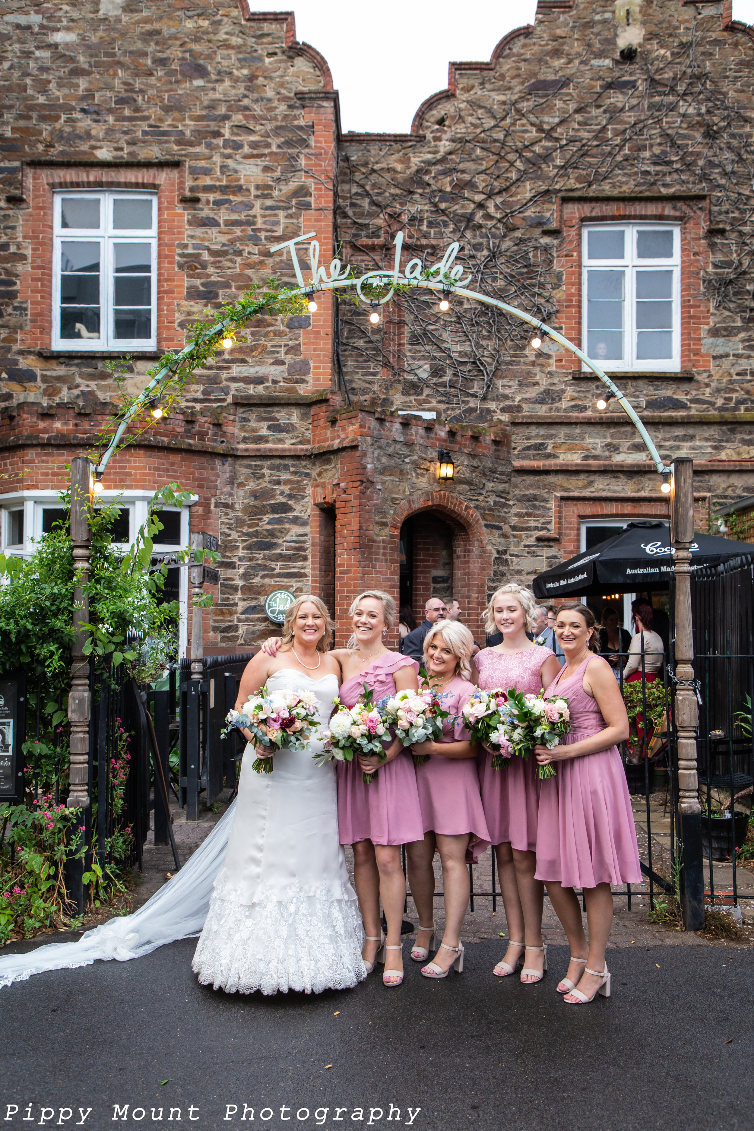 E&S wedding - Bride & bridesmaid under sign copy.jpg