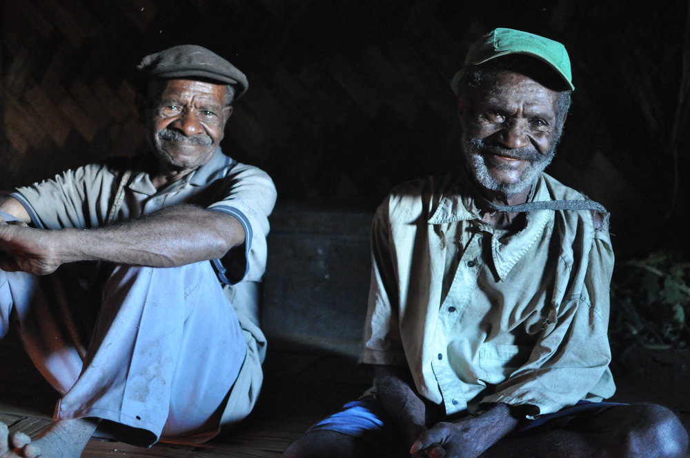  Two men at fireside. Gua, 2009. 