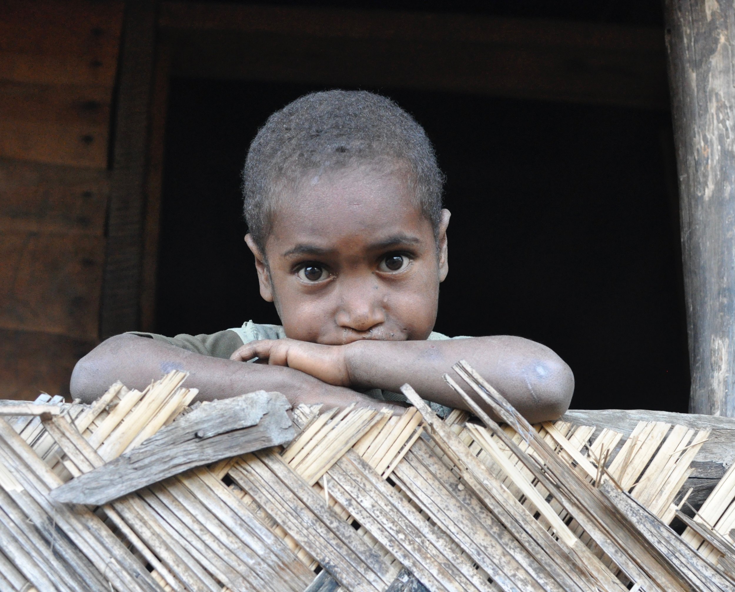  Boy resting on a railing outside our residence. Gua, 2009. 