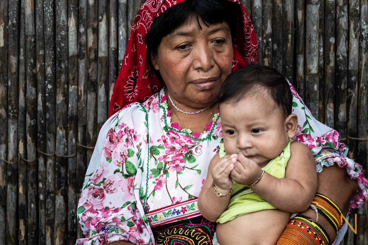 Portrait of Edita Lopez holding her grandson.