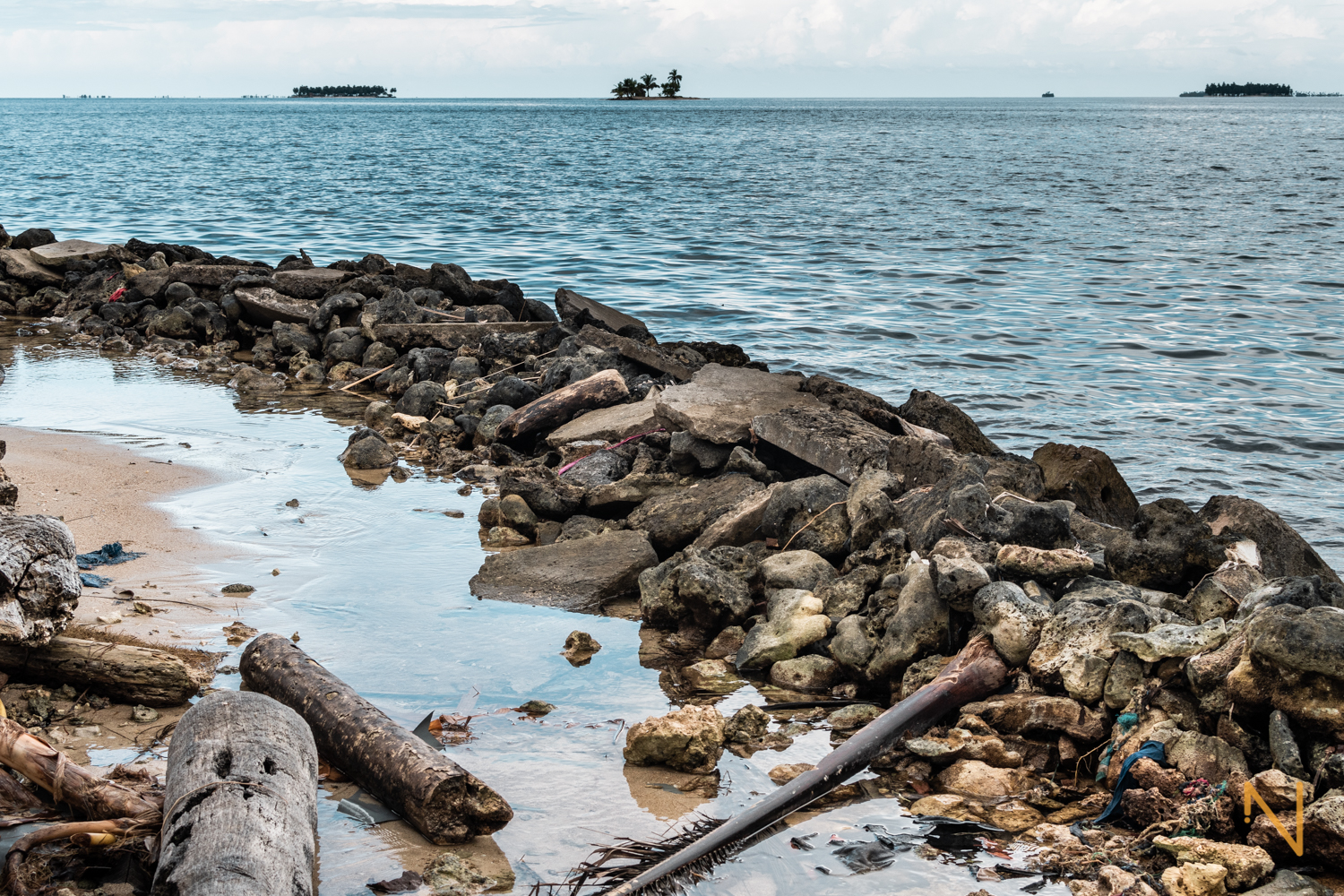 In an attempt to stop the waters and reclaim land from the sea, rudimental barriers are made with a rocks, dead corals, sand and sometimes trash.