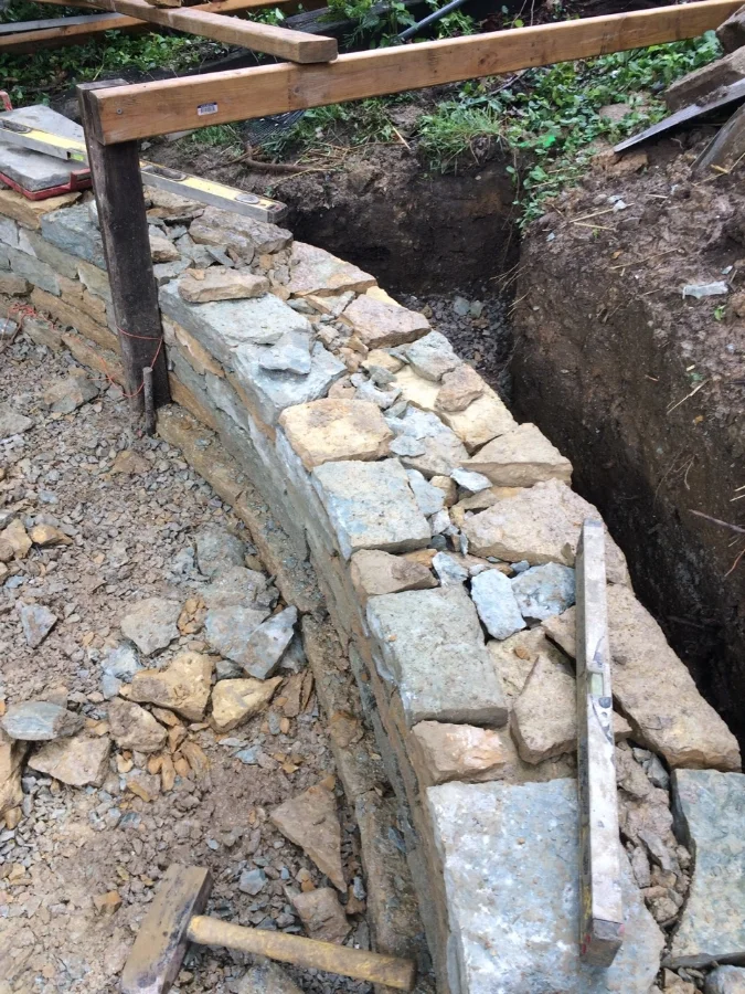Timeless beauty + built to last. The patio stone wall was constructed without mortar allowing it to flex with the freeze and thaw of our winters and allows water to pass through it. 