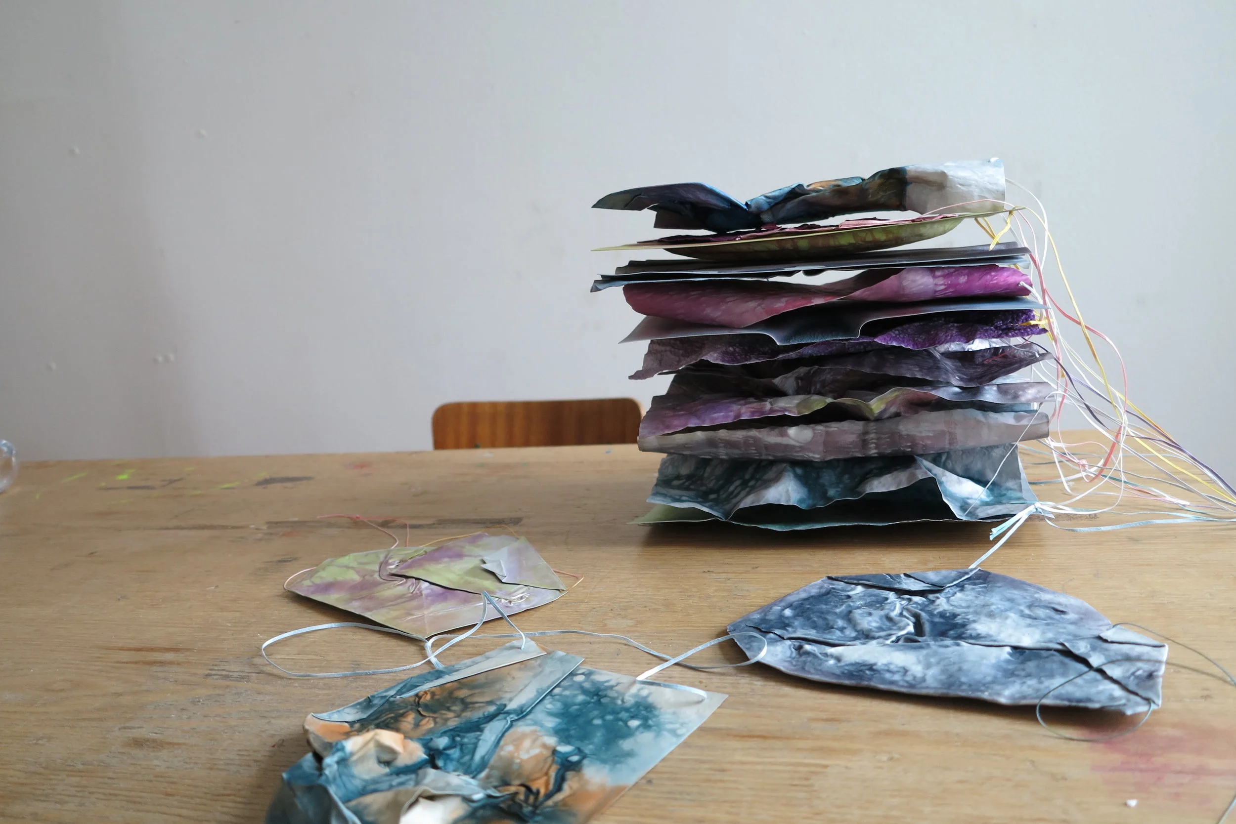 Anna Norrgrann, pile of A4 aluminum sheets/necklaces in the studio, photo by the author