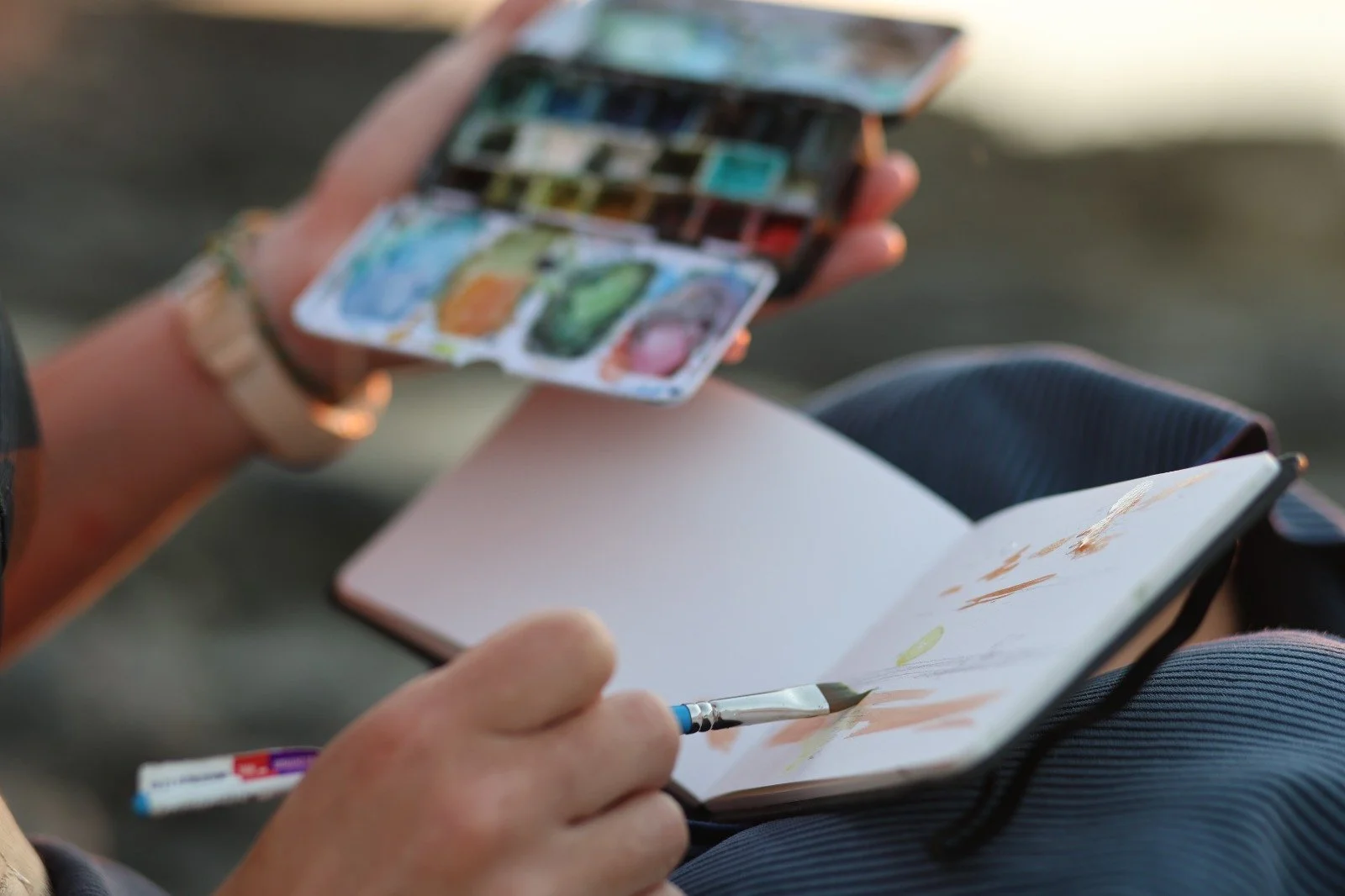 Student painting with watercolor