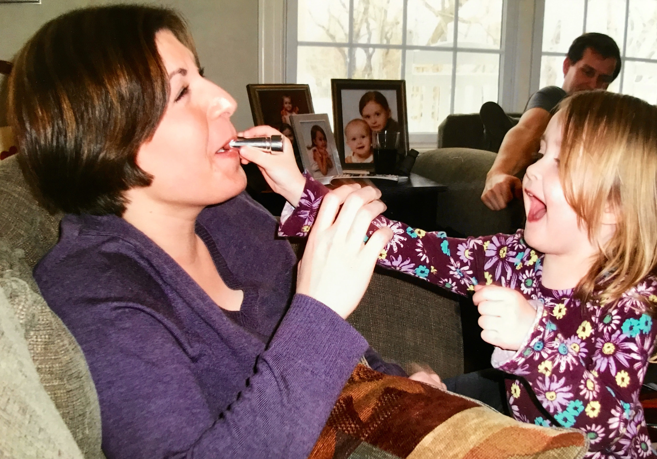 My friend’s daughter Aurora feeding me lipstick!