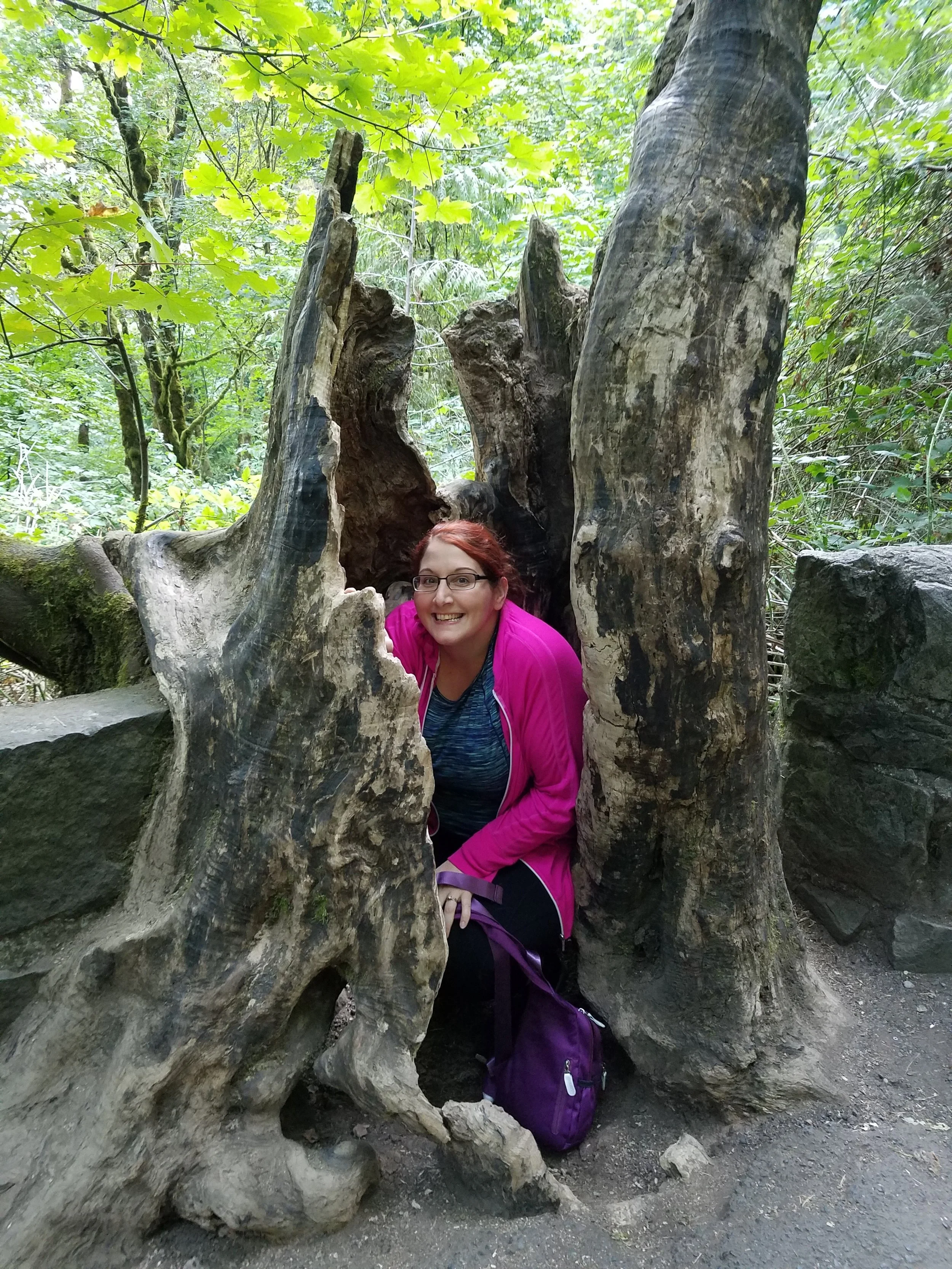 Jen hiding in a tree stump.jpg