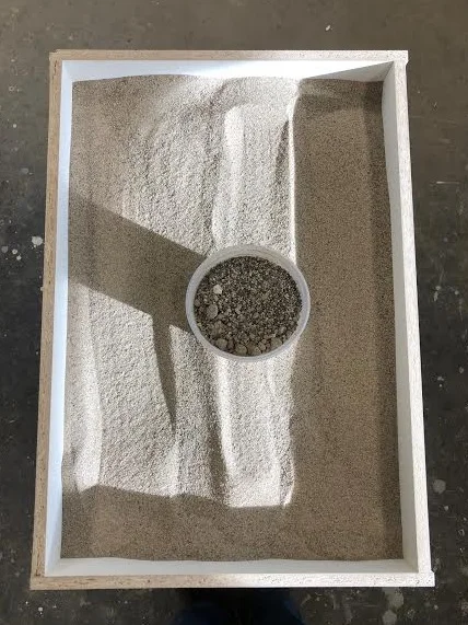 Sifted through the sand and removed pebbles and poured into a melamine base. For finer sand could have used silica sand (used for sandblasting)