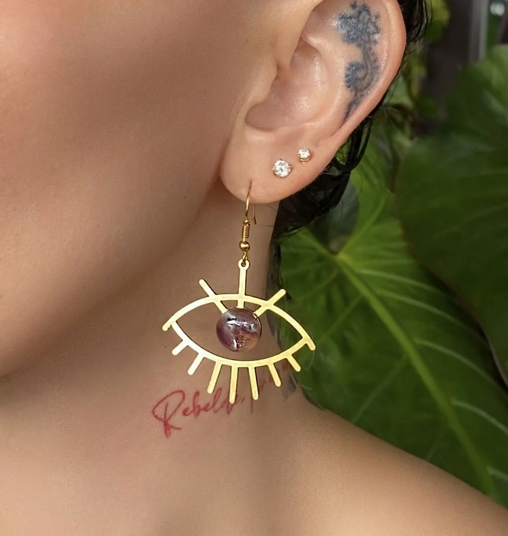 Shop Amethyst Evil Eye Earrings in gold. Our Amethyst evil eye earrings are from ethically sourced crystals from around the world.