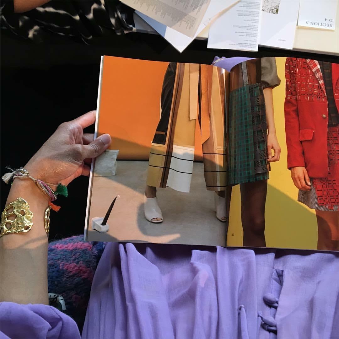Seated at the Pratt Fashion runway show, 2016–70s lilac cotton Bohemian dress and 80s sweater, Beacon’s Closet, NYC; brutalist gold cuff