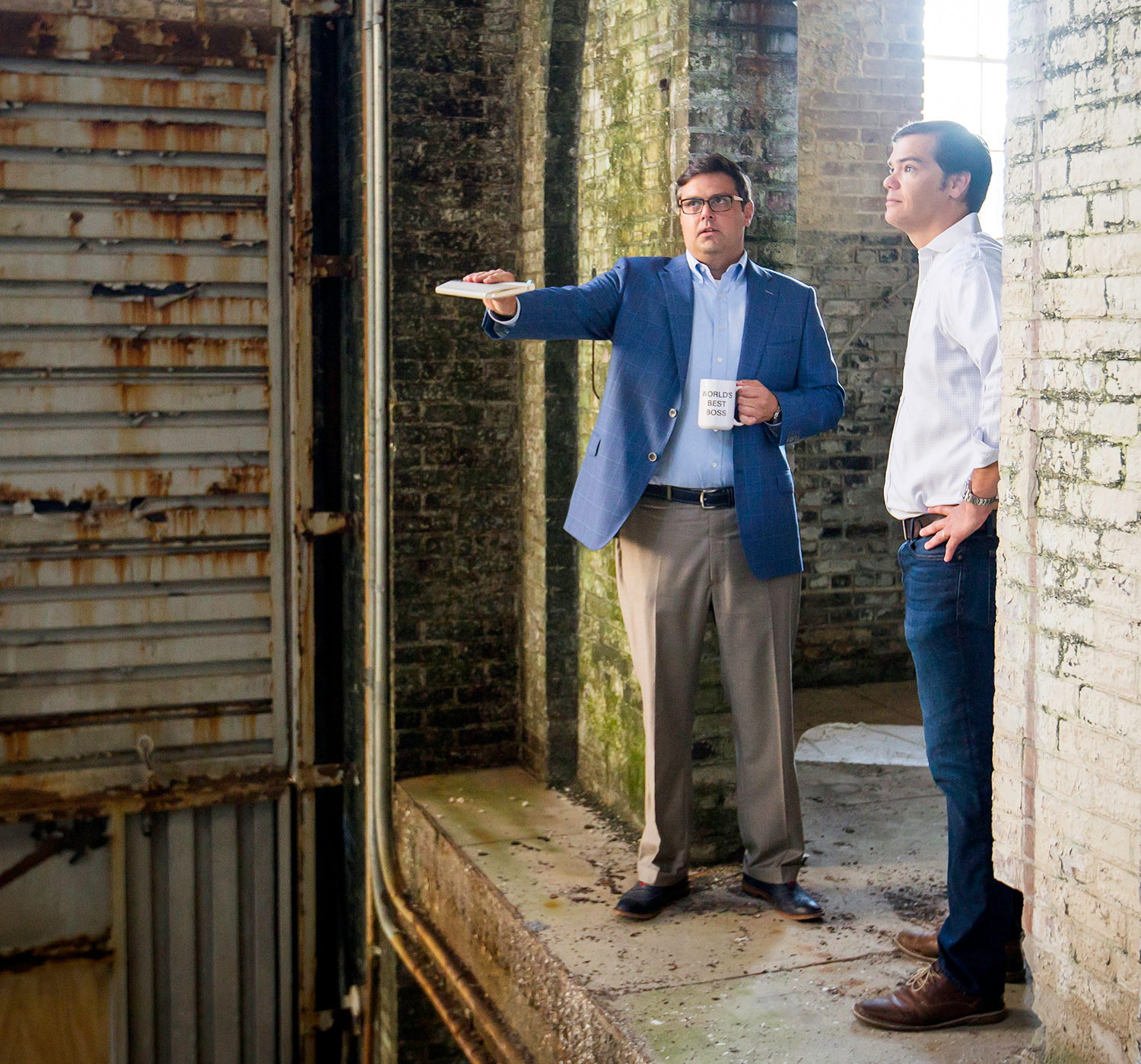 Architect Dyke Nelson, left, and DNA Workshop staff member Abe Kinney inspect the old Entergy building site on Government Street.