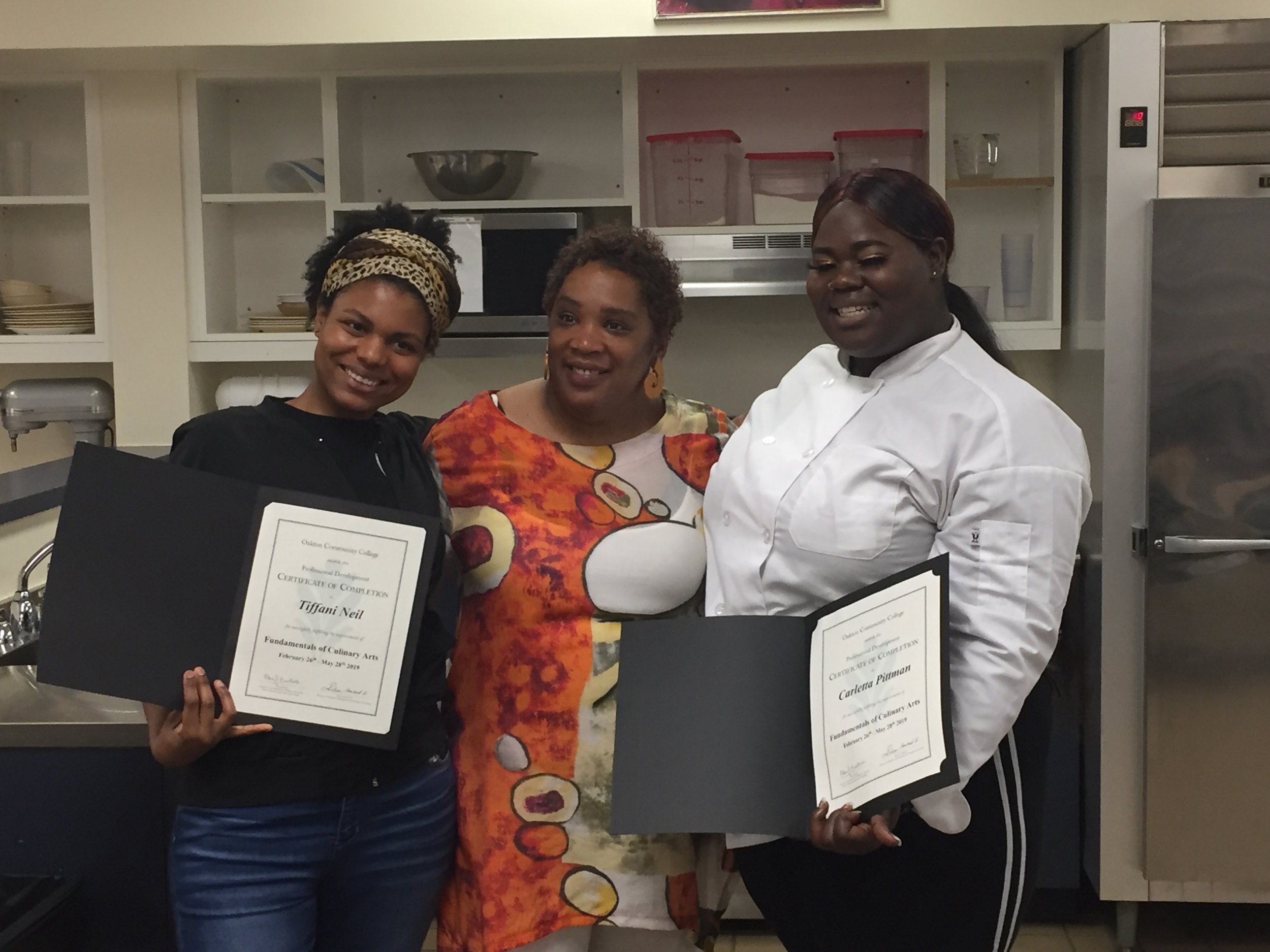 Culinary Career Pathway participants Tiffani and Carletta receiving their Fundamentals of Culinary Arts Certificates