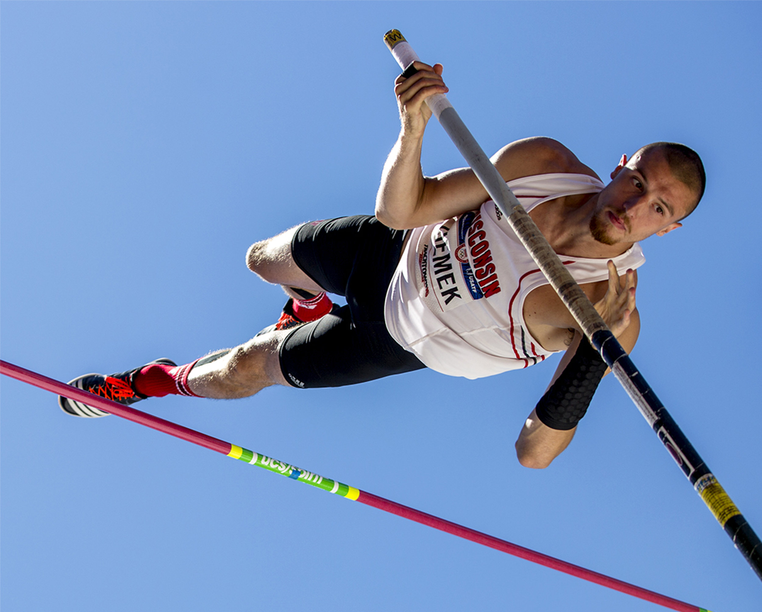  Wisconsin's Zach Ziemek vaults himself up and over the bar in the pole vault portion of the decathlon at the Olympic Trials. Ziemek won the pole vault with a height of 5.25m.&nbsp; 