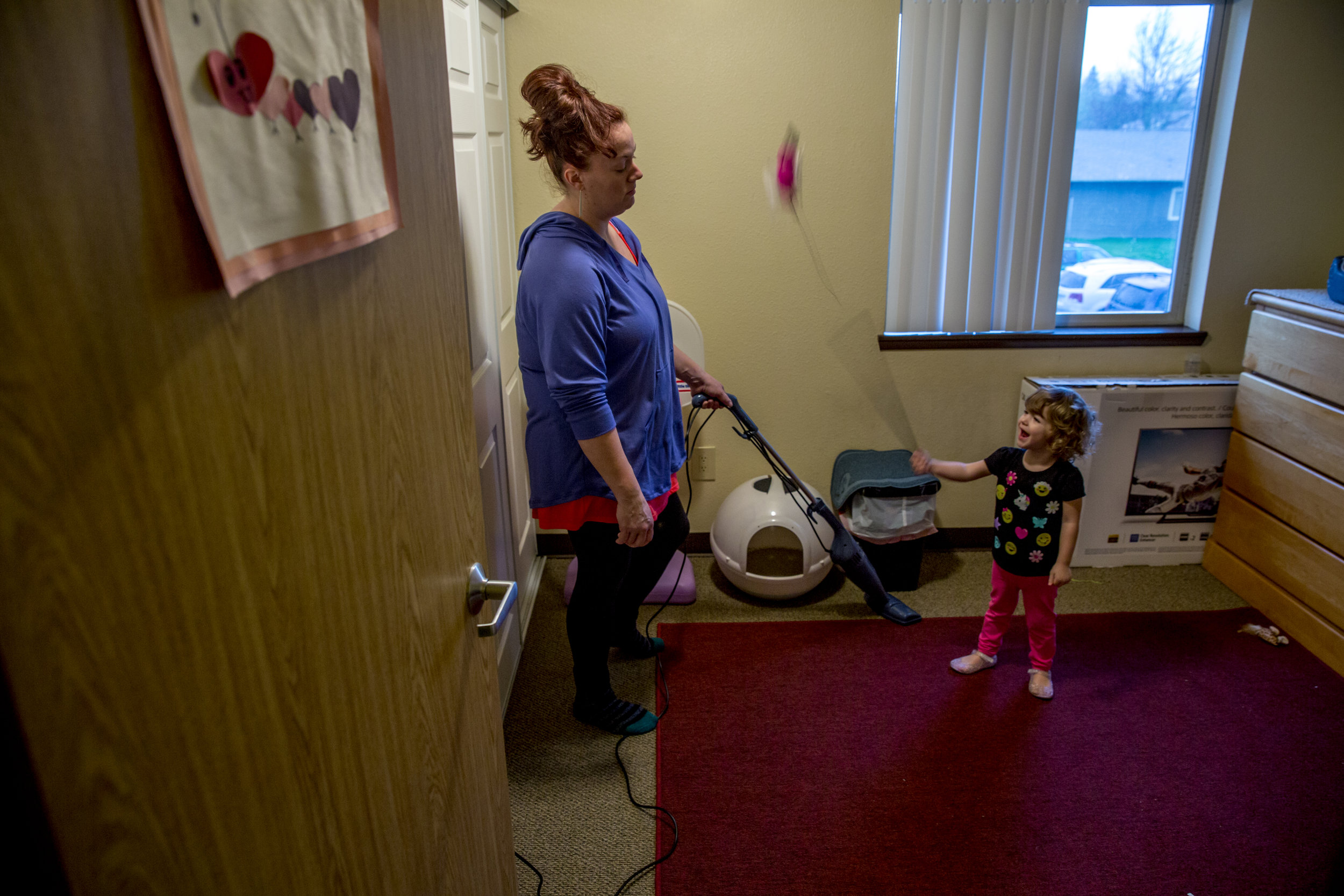   Sarah vacuums the room that she’s devoted to her new cat, a pet she said that helps her stay away from smoking, as Suzanna begins swinging one of the cat toys wildly. "Don't hit me or the cat with that," Sarah says in a worn but stern voice.  