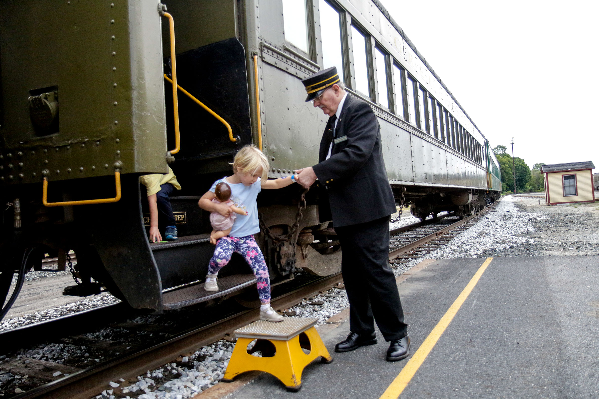  Brian McGregor, the passenger representative of Green Mountain Railroad, helps Nicole Piasecki, 3, of Hanover, N.H., off the train at the end of her 40 minute train ride at Glory Days of the Railroad in White River Junction, Vt., on Saturday, Sept. 