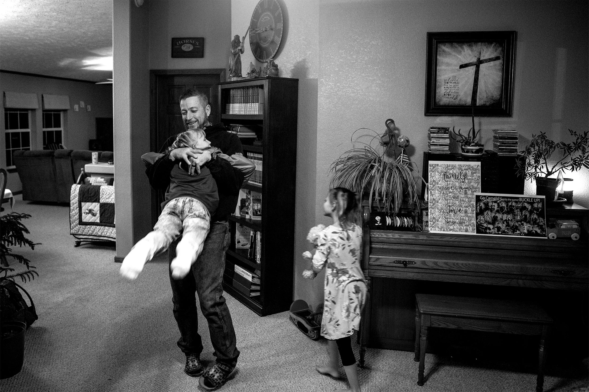  Derrick Mitchell spins Natalia around during a family get-together on Wednesday, Jan. 9, 2019. After Derrick's youngest graduated high school he and his wife thought they were done. "Now we're getting ready to do it all over again," Derrick says. 