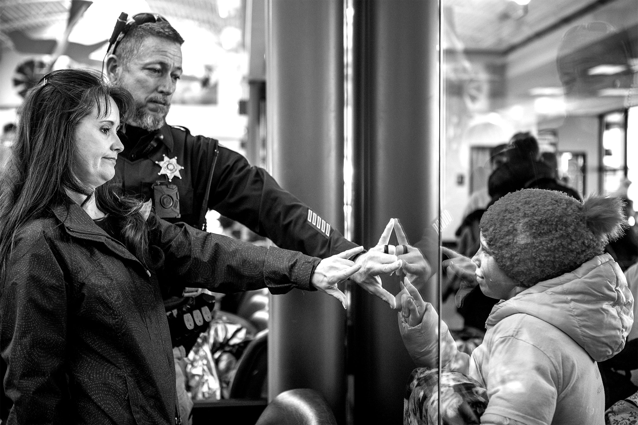  Derrick and Michelle Mitchell say their goodbyes to Natalia from the other side of the security checkpoint. The next four week trip for Host Ukraine isn't until the Summer. Many of the families are committed to fully adopting the orphans before then