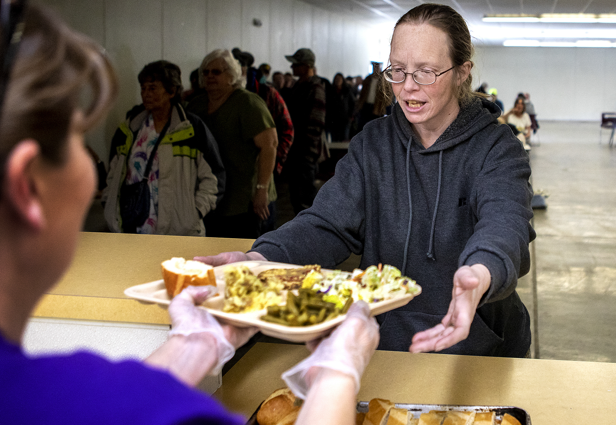  Andrea receives a tray of food at the Gillette Soup Kitchen. The meal is their one hot meal of the day. Resources offered by the Council of Community Services like the soup kitchen have been a great help to Andrea and her family. "There is hope out 