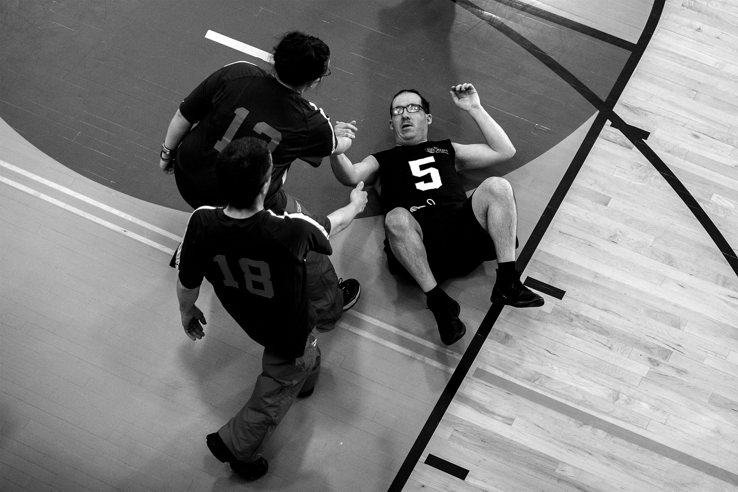  Billy Buckey is helped to his feet by rival players Amber Trieber and Jackson Ventling, (18) during the basketball competition of the Special Olympics Area Games on Thursday, April 11, 2019. For many of the athletes competing the family and camarade