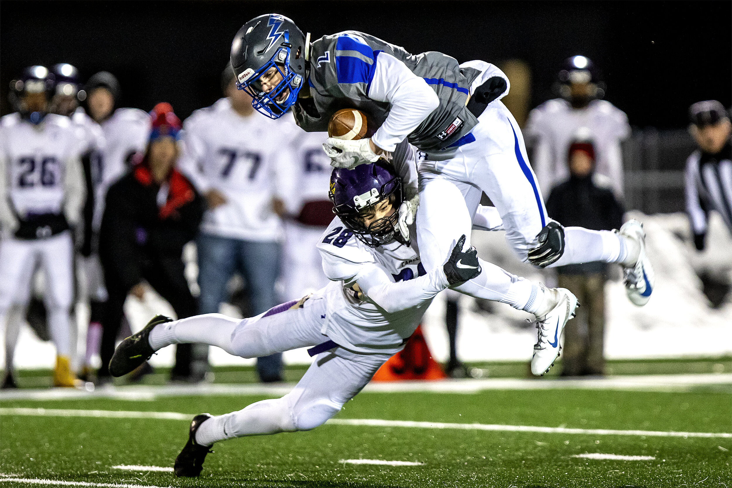  The Bolts' Blaine Allen is lifted into the air by the Camels' Mason Dykes after catching a pass in Friday's playoff game. The Bolts defeated the Camels 24-20. The Bolts,  ranked at number one with an undefeated season, received an unexpected challen