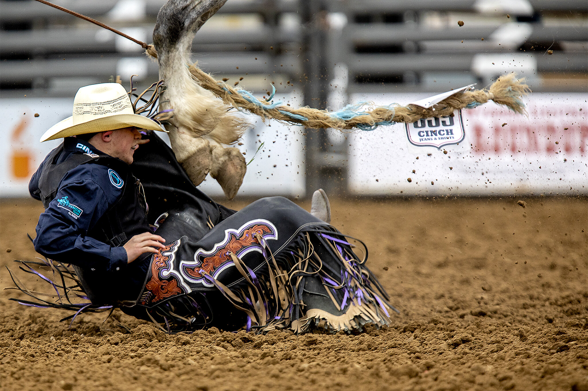  Kayson Dory gets an up-close view of his horses hooves upon being thrown off in the saddle bronc competition on Saturday, June 8, 2019. Once an athletes is thrown off a horse or bull, if they don't get away from the bucking animal soon they are risk