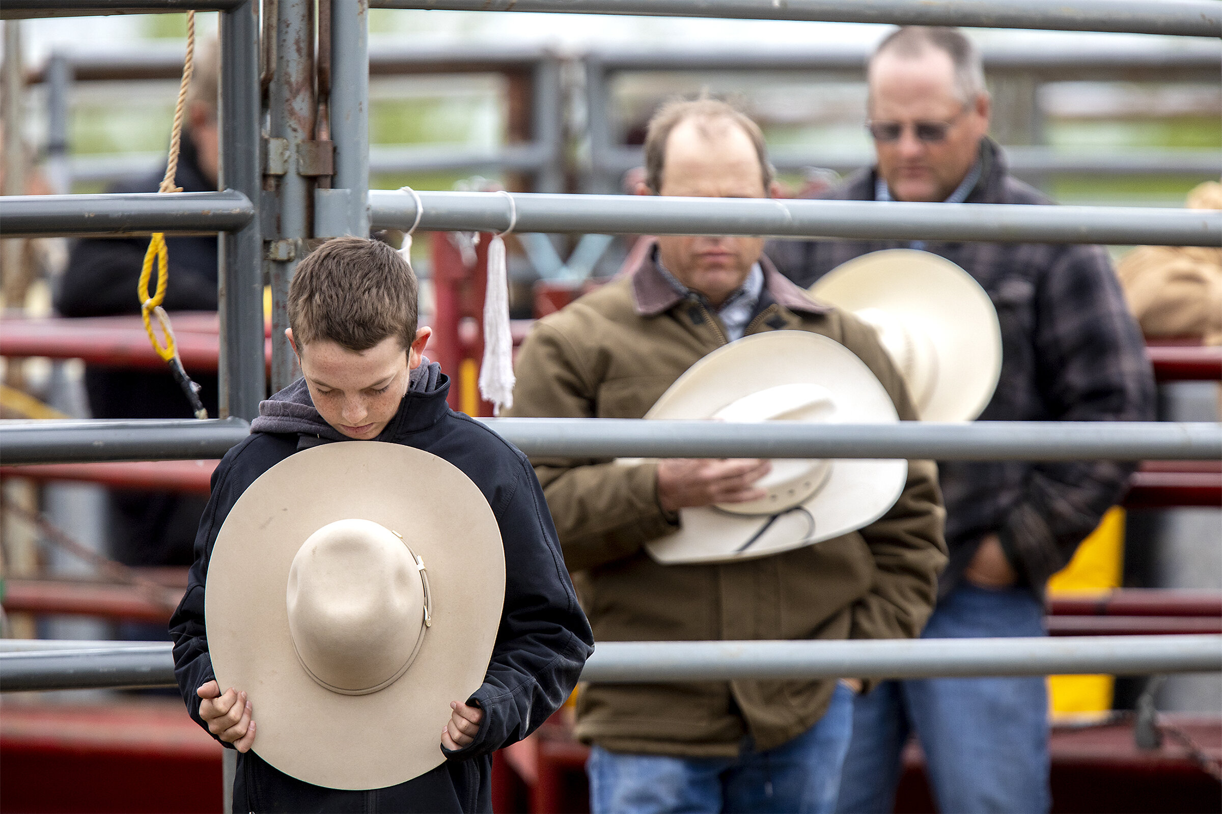  Cowboys young and old remove cover and bow their head for the traditional pre-rodeo prayer on Saturday, June 8, 2019. 