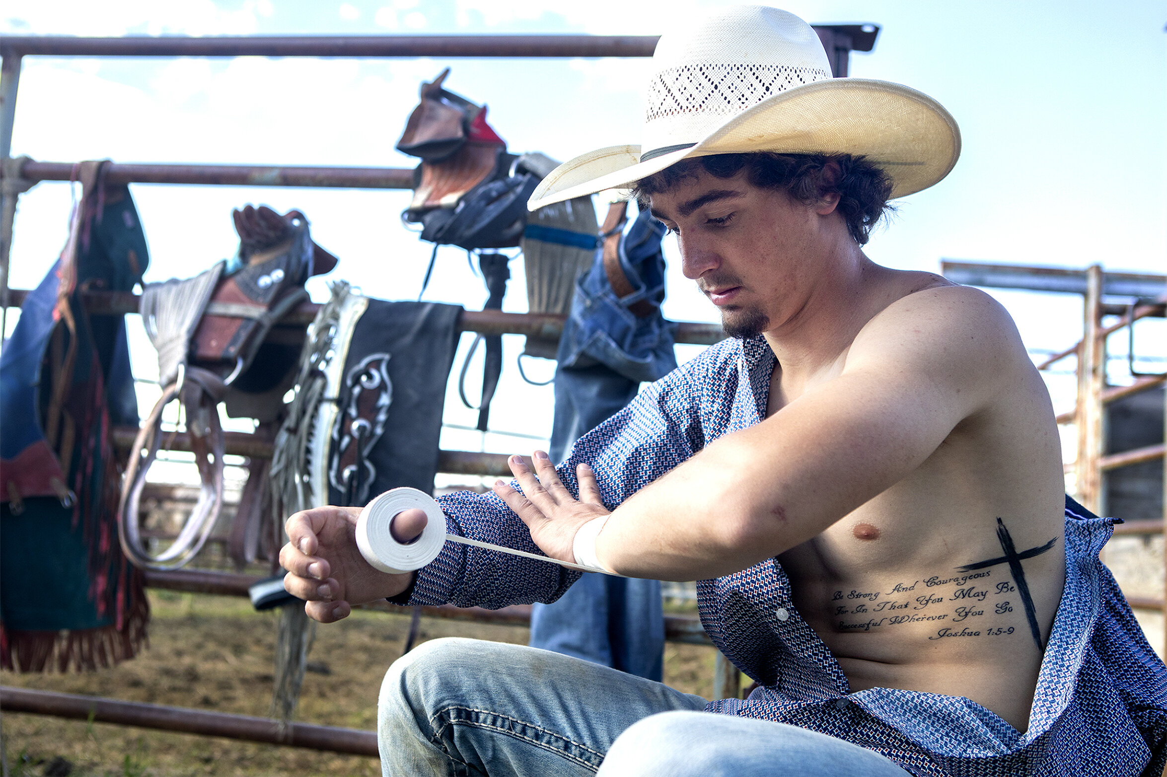  Donny Proffit tapes up his wrist ahead of the bareback competition on Friday, June 7, 2019. The tape holds things together and keeps the cowboys from pulling a muscle. Proffit’s tattoo reads “be strong and courageous for in that you may be successfu