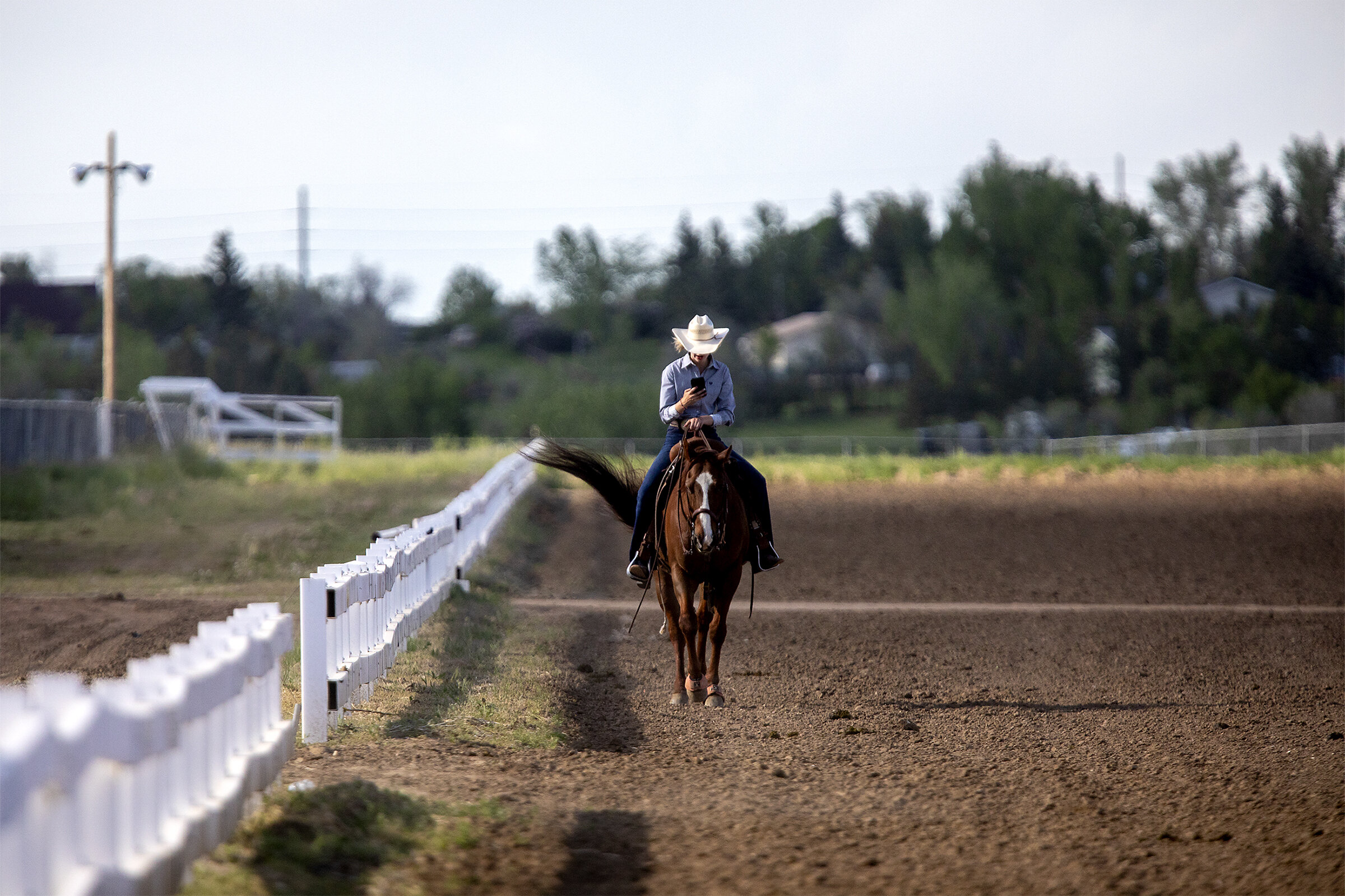  Kaycee Thomas walks her horse along the fencing beside the central arena on Friday evening, June 7, 2019. 