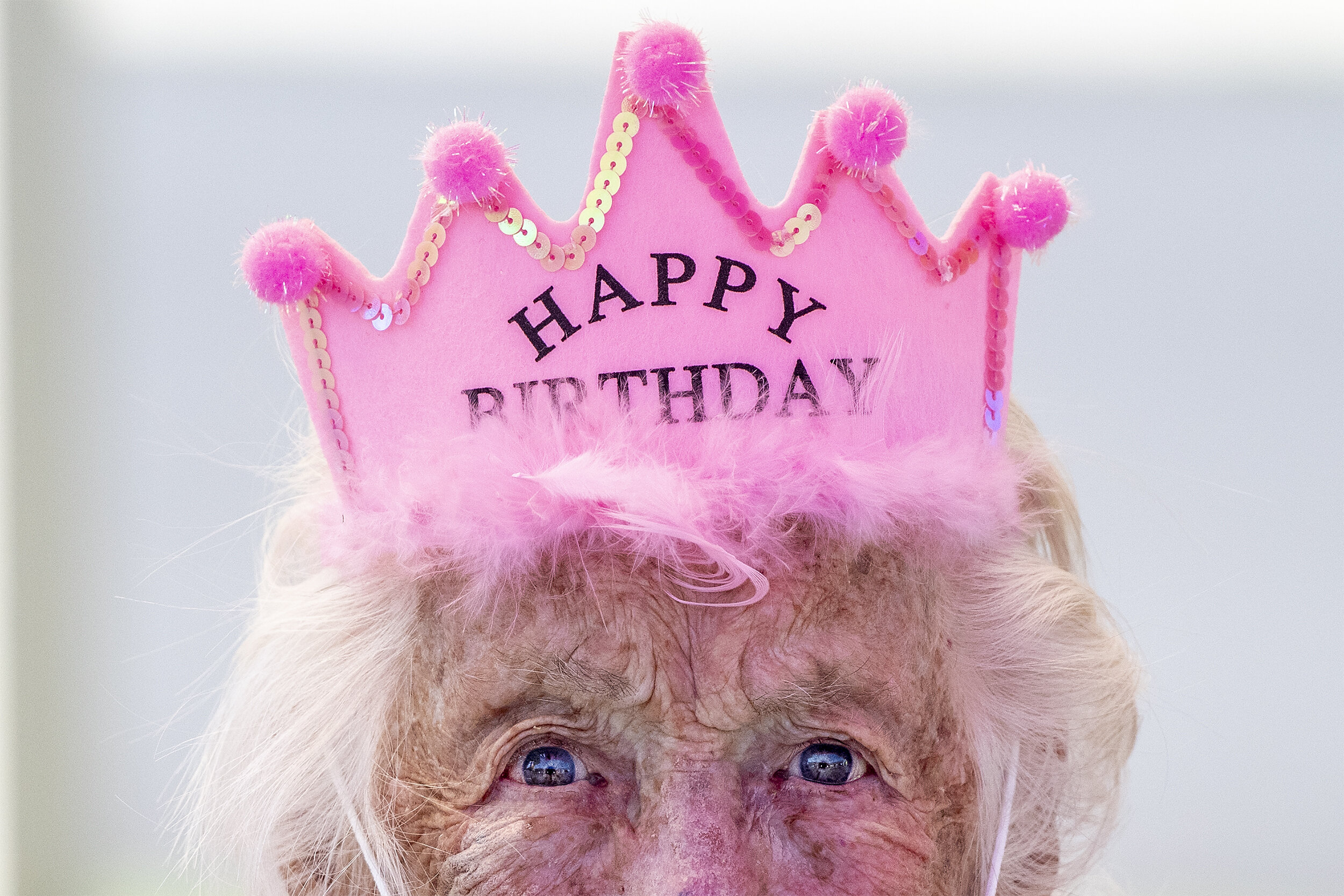  A birthday crown sits atop Martha Engledow's head for her 102nd birthday as she awaits a drive by parade of her friends and family at Brookdale Senior Living on Saturday, July 4, 2020.  