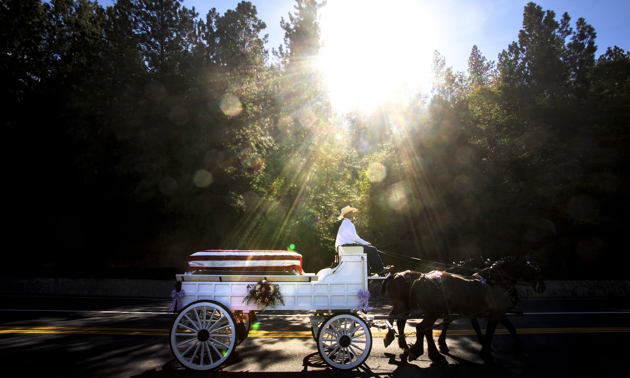  Tom Hayes is carried in horse drawn carriage to his final resting place in the Orofino Cemetery on Friday. Tom, 41, died on July 21 in a helicopter crash while assisting firefighters in the Moose Fire, near Salmon, Idaho. His father, Tim Hayes, said