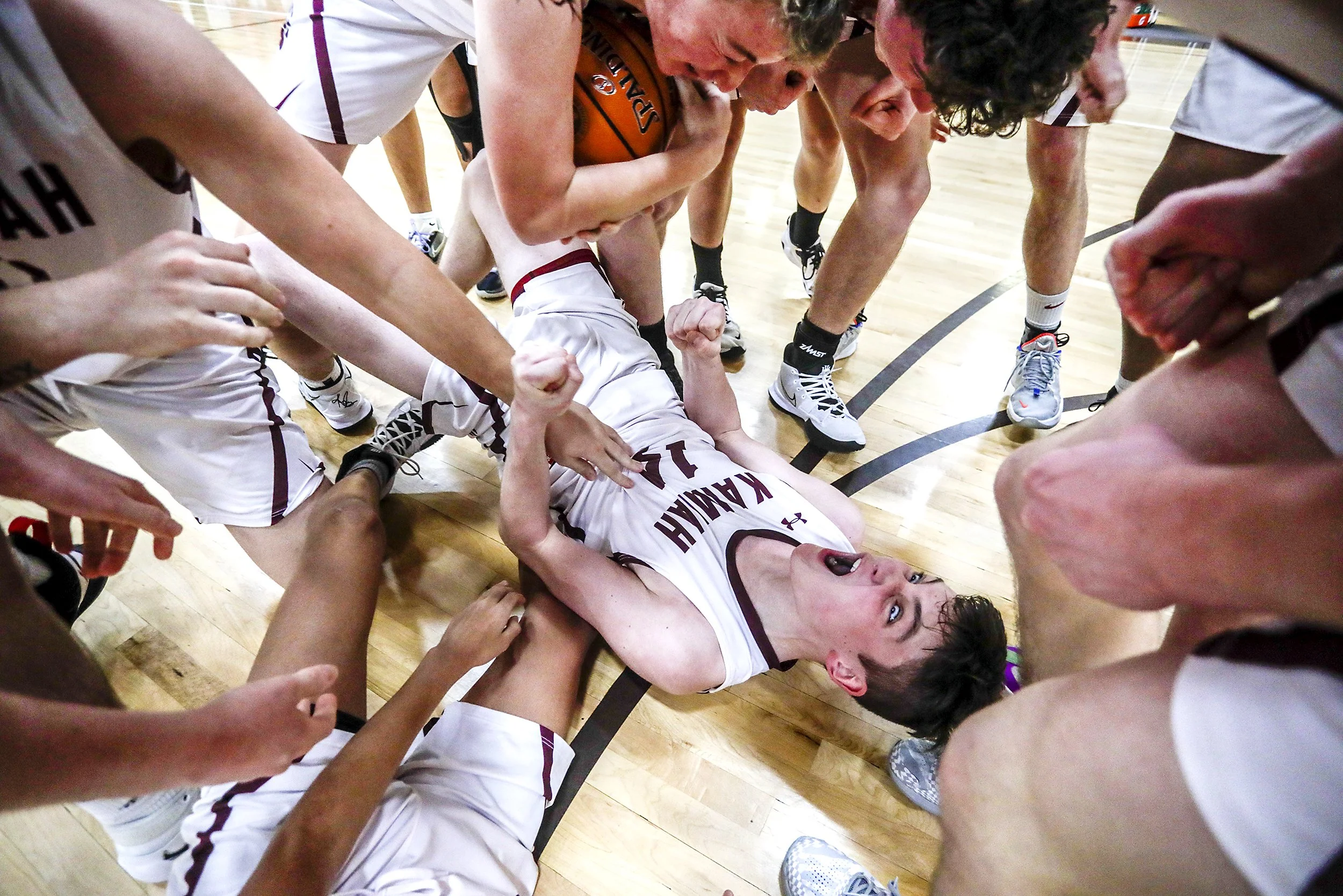  Kamiah David Kludt lets out a yell as his teammates surround him as the team celebrates their 42-40 victory over Grace during round two of the Idaho High School boys state basketball tournament at Vallivue High School on Friday. 