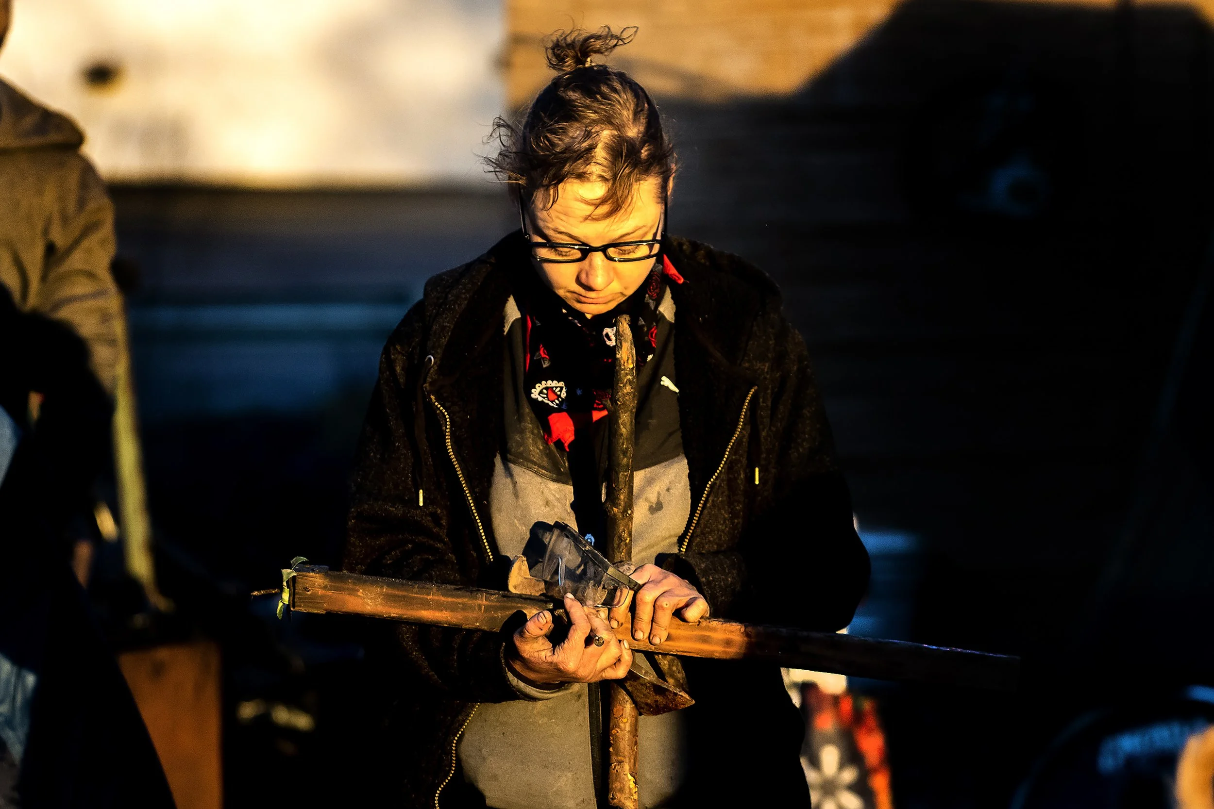  Rikki Nail-Hart holds two sticks as she and other residents of a homeless camp behind Walmart work on packing up their belongings before moving to a new location Monday, Feb. 12, 2024, in Clarkston. Homeless residents that had been staying at a near
