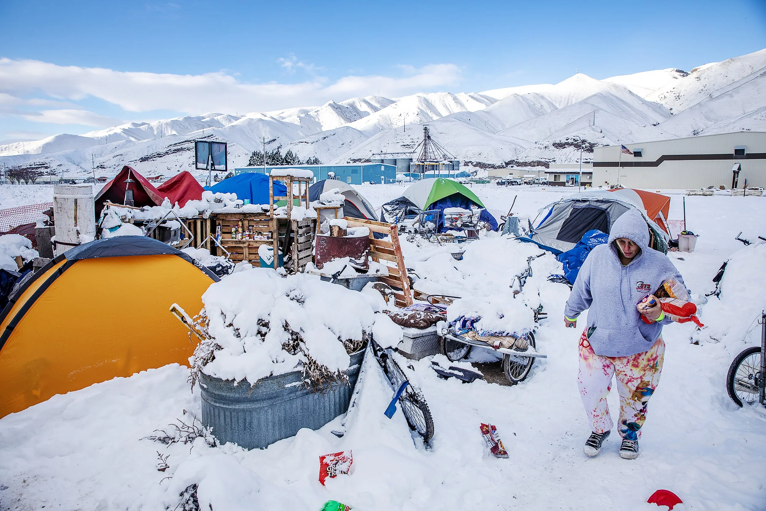  A resident walks through the homeless camp on Friday, Jan. 12, 2024, in the aftermath of late night snowstorm that covered the Lewiston-Clarkston Valley. Among the camp’s biggest needs was warm clothes, propane, and material to burn. 