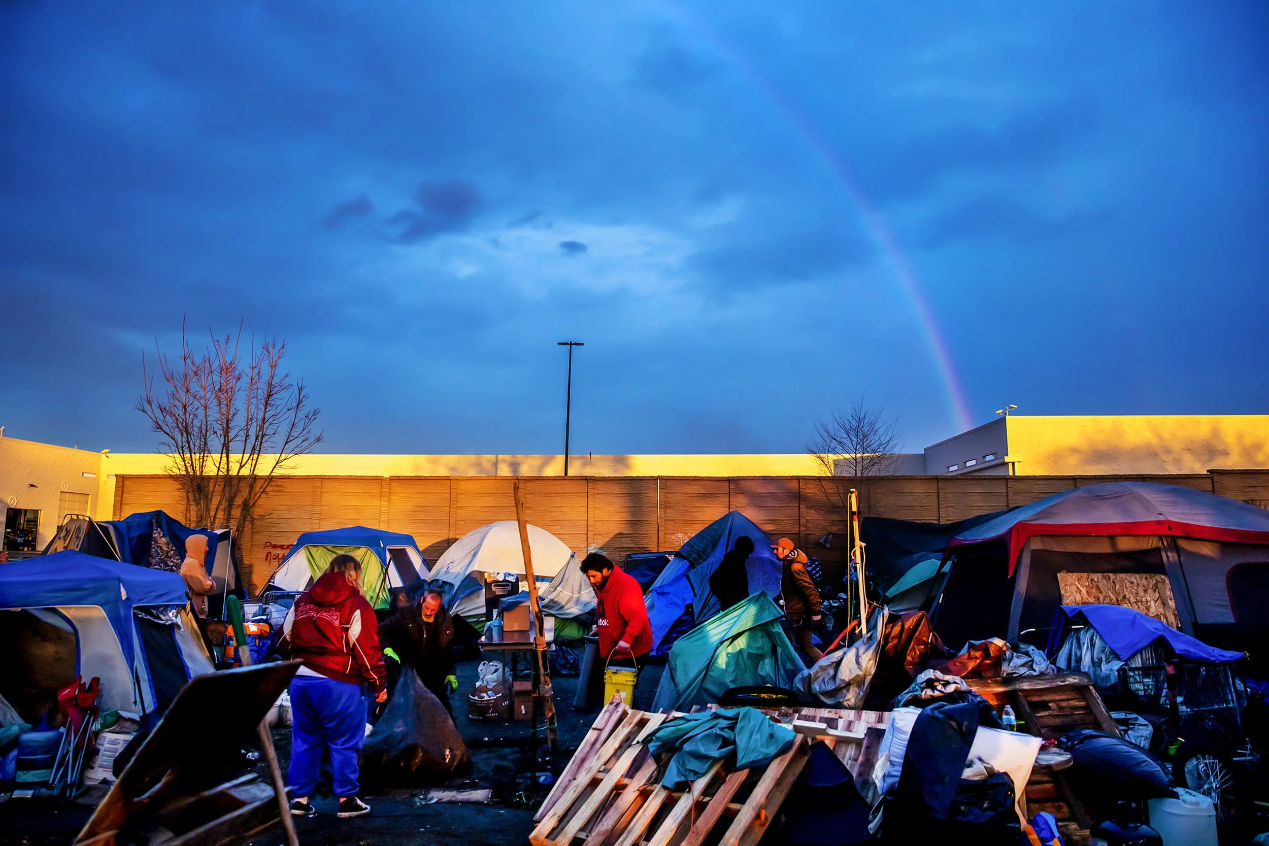  A rainbow forms in the distance as residents of the homeless camp work to pack up their belongings Monday, Feb. 12, 2024, in Clarkston. “I think God is working here,” said Mary Egeland, one of the volunteers who helped camp residents move their belo