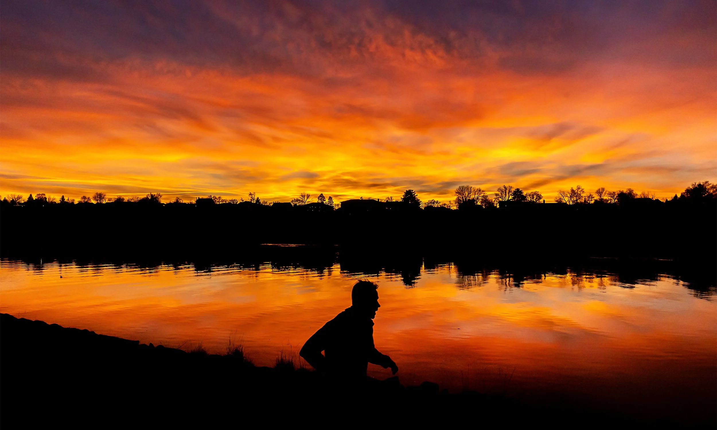  A person jogs down the Lewiston Levee Parkway Trail as the sunset lights up the Snake River on Wednesday, Feb. 4, 2026, in Lewiston, Idaho. 
