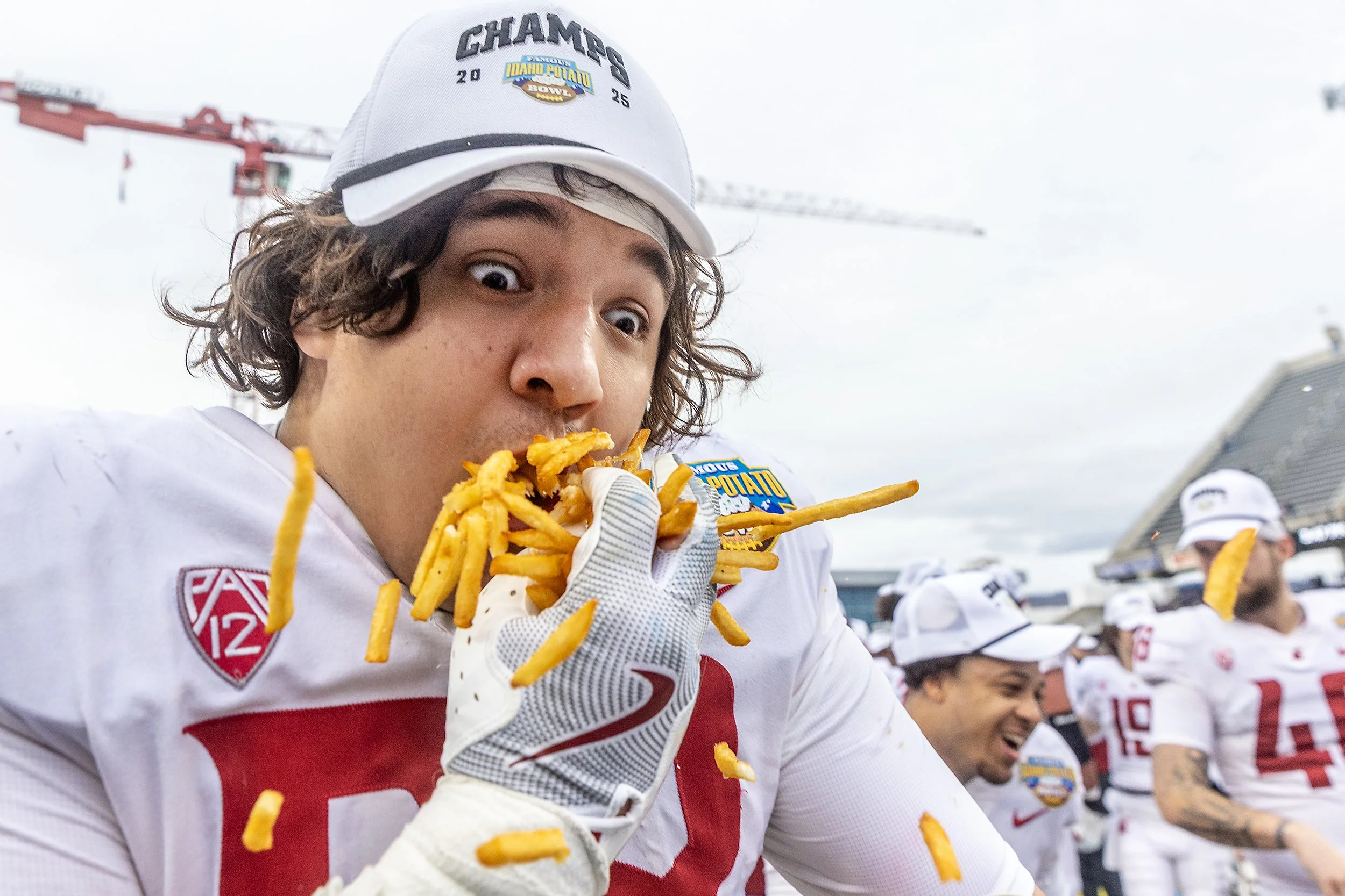  Washington State defensive lineman Malaki Ta'Ase eats French fries following the Cougars victory over Utah State during the Famous Idaho Potato Bowl on Monday, Dec. 22, at Albertsons Stadium in Boise. Washington State defeated Utah State 34-21., 