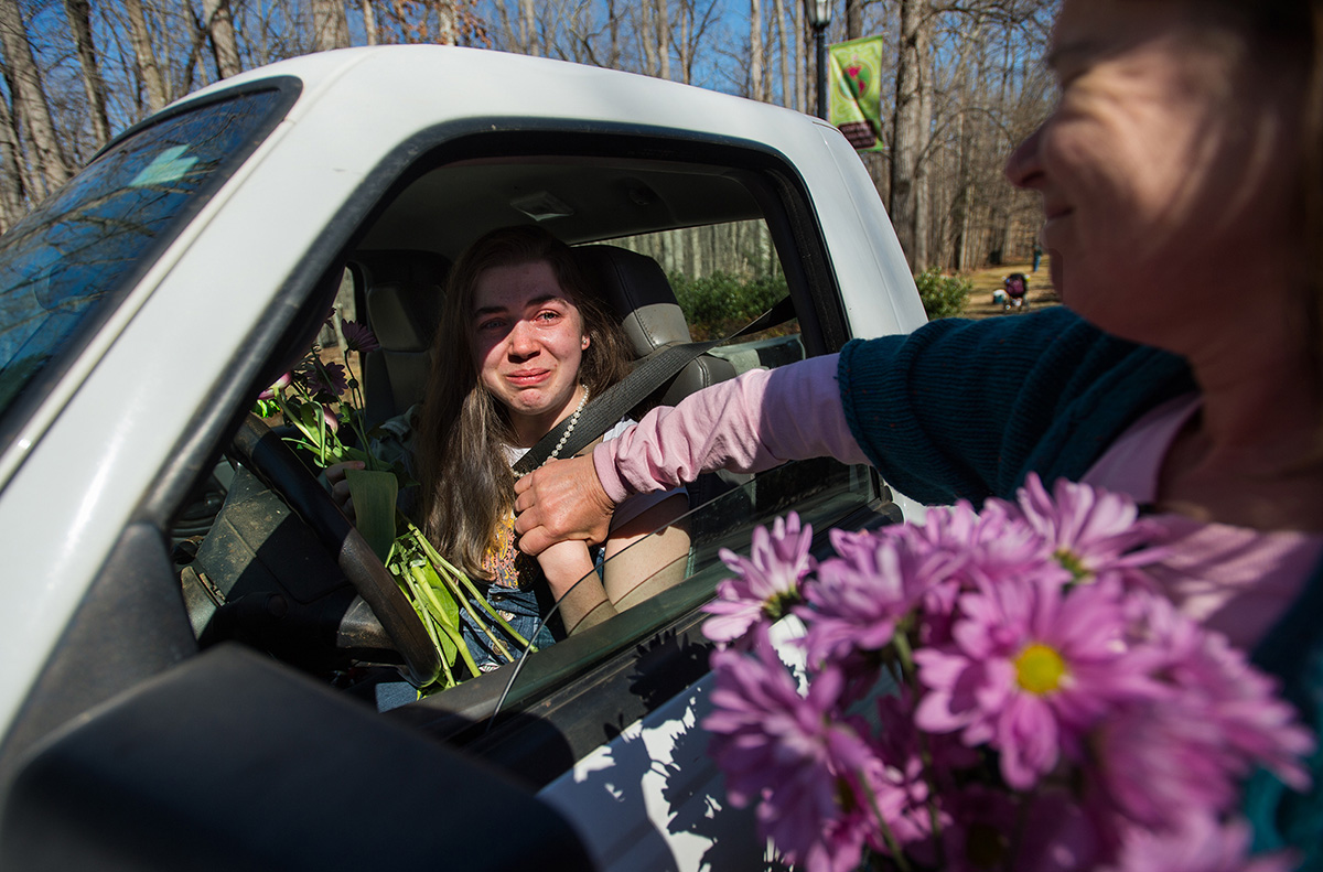 Alum Terry Evans (right) consoles junior Katy Drew as the Sweet Briar community welcomes back their students from spring break in Amherst, Va. Sweet Briar College announced the school would close due to financial issues, but after months of legal struggle, leaders of Sweet Briar College and the Saving Sweet Briar movement reached an agreement to save the college and keep it open for the 2015-16 school year under new leadership.