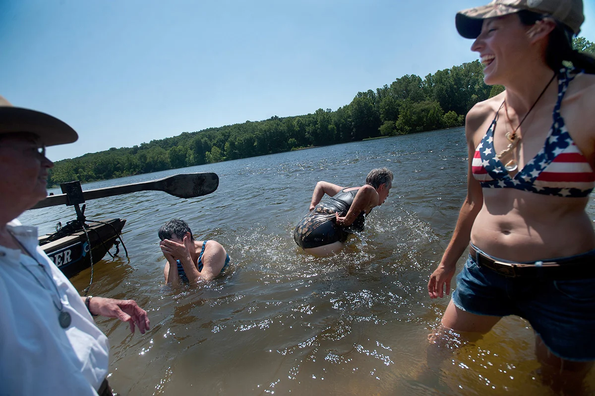 Terry Zimmerman shows her backside to Rhonda Baker after their crew riding the Lady Slipper made it through Goolsby Falls during the 29th Annual James River Batteau Festival en route from Howardsville to Scottsville, Va.