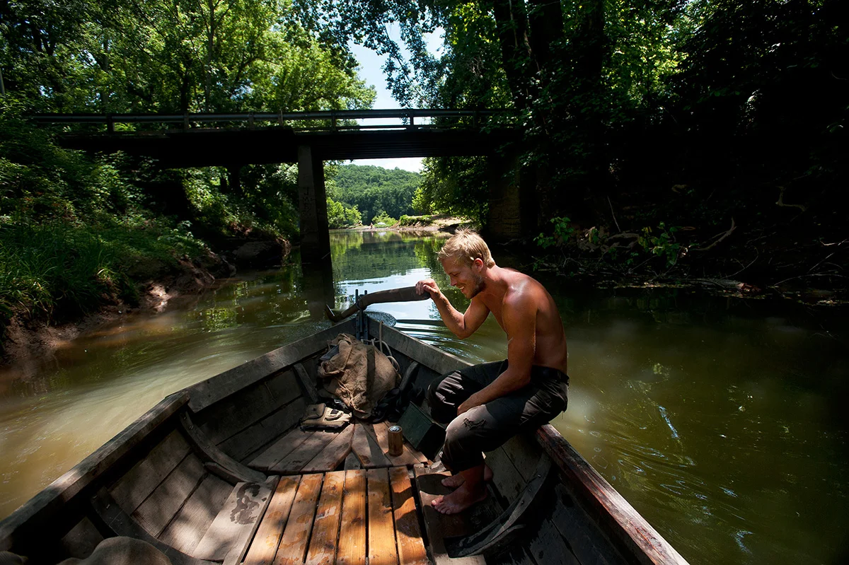 Sebastian Backström helps navigate the Mary Marshall out of a tributary of the James River by managing the sweep as they head towards Scottsville, Va. during the James River Batteau Festival.