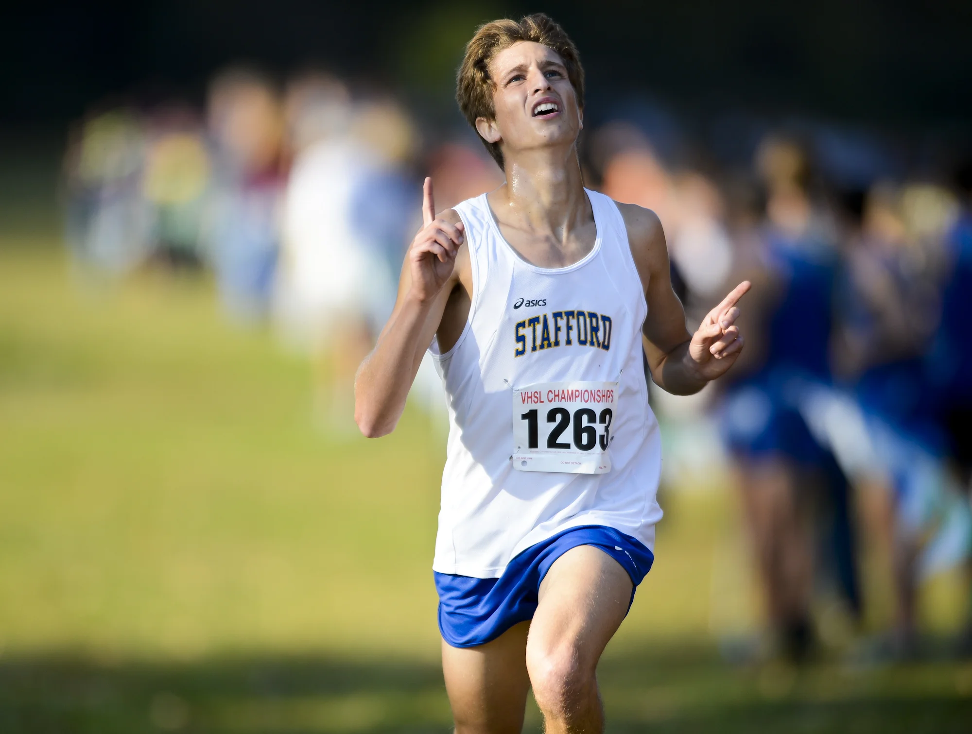 Joey Abbatiello of Stafford signals “#1” as he finishes first place at the Conference 4 Cross Country Championship Meet at Willowmere Park in Stafford, Va.