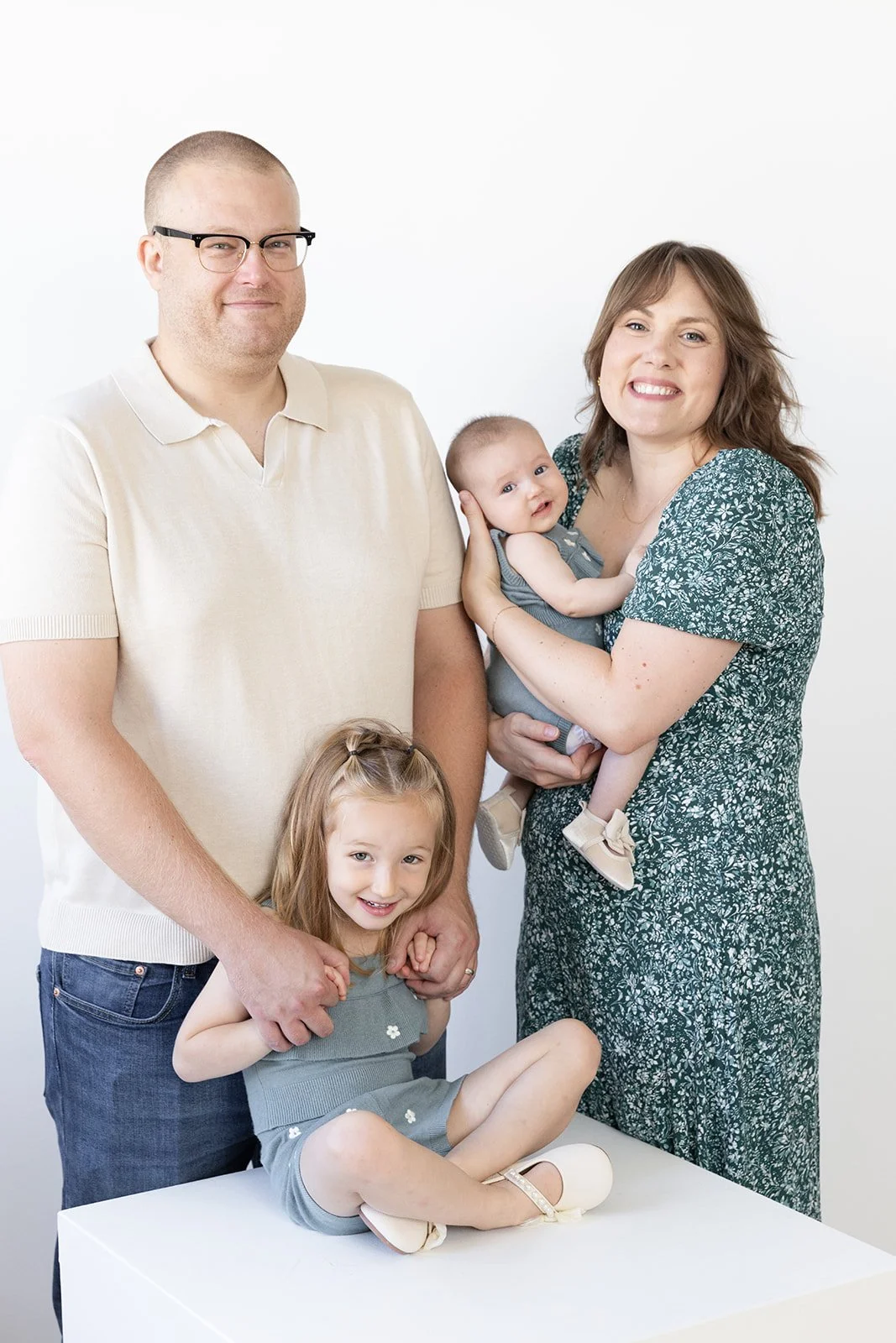 Parents and children laughing during a studio family photo session