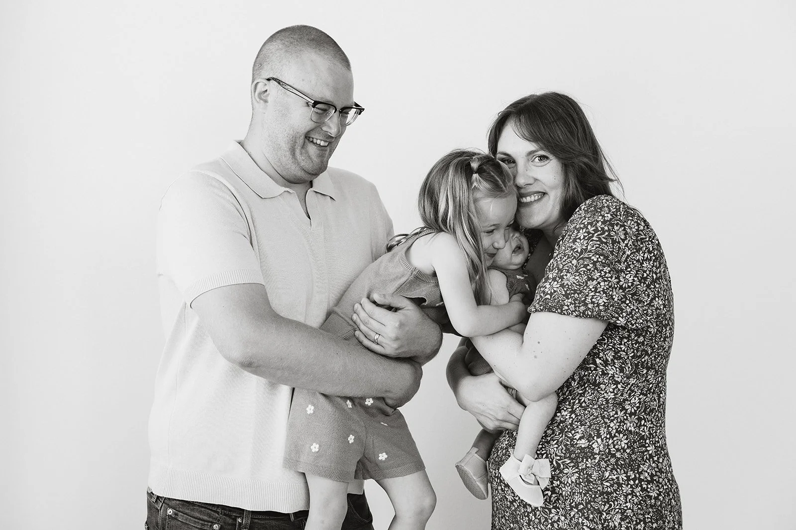 Parents and children laughing during a studio family photo session