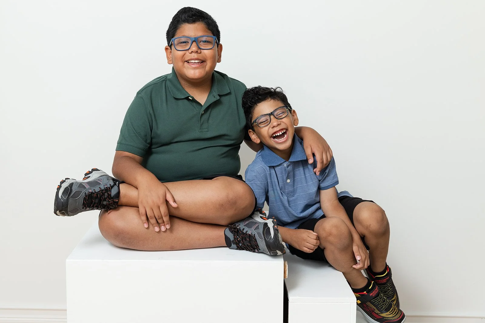 Parents and children laughing during a studio family photo session