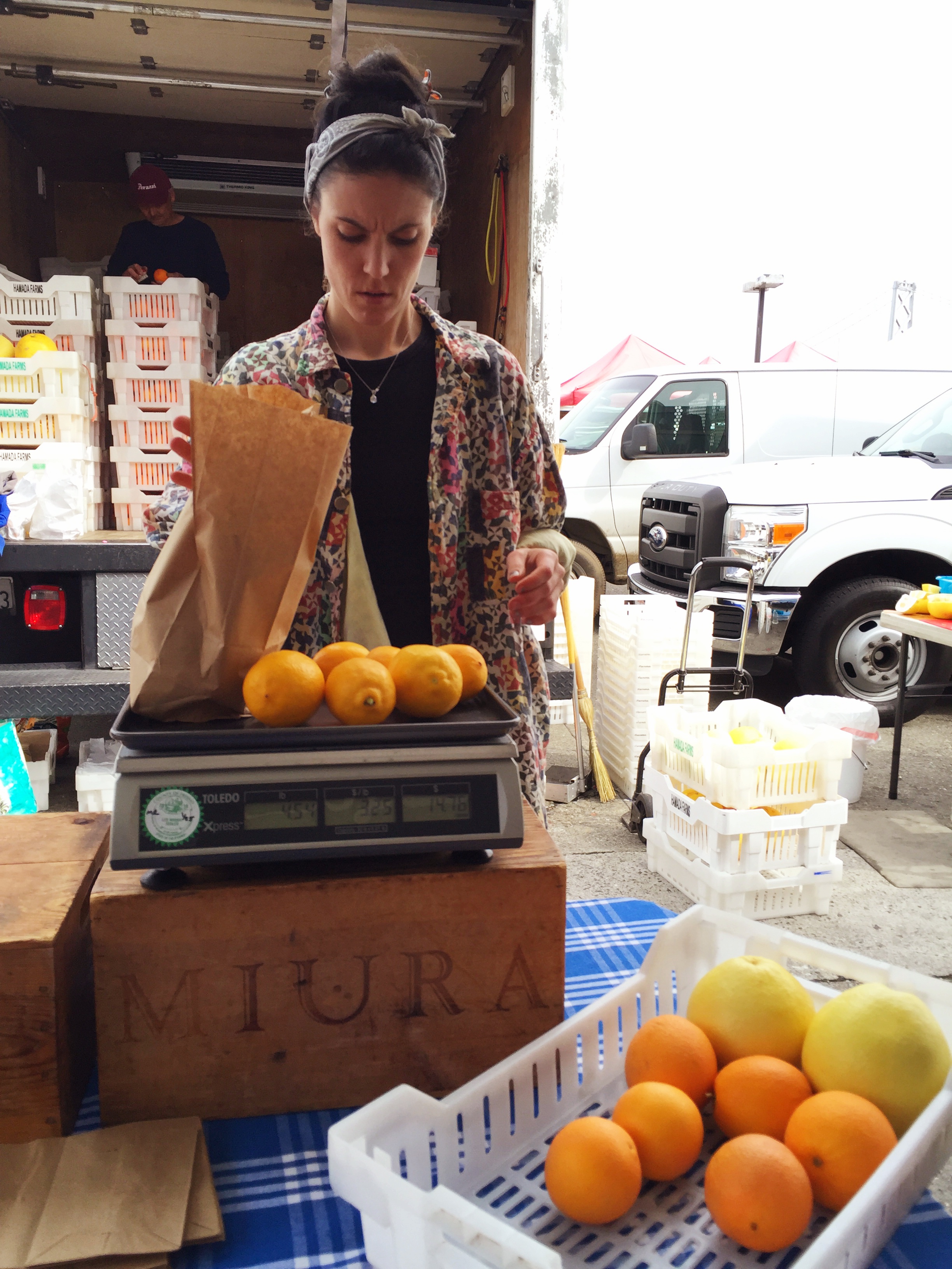 At the market weighing out my bounty