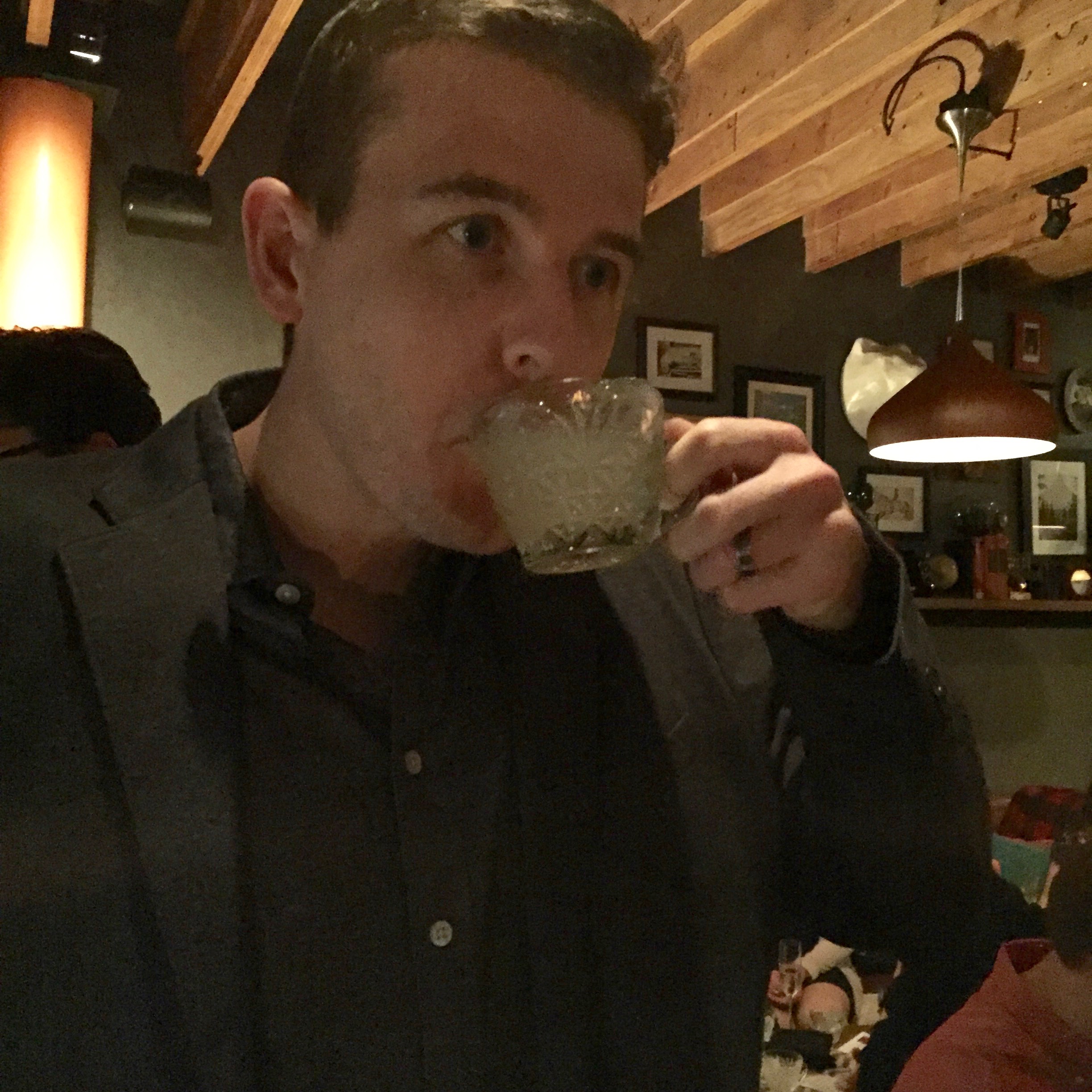 My husband enjoying his first round of punch in a little tea cup