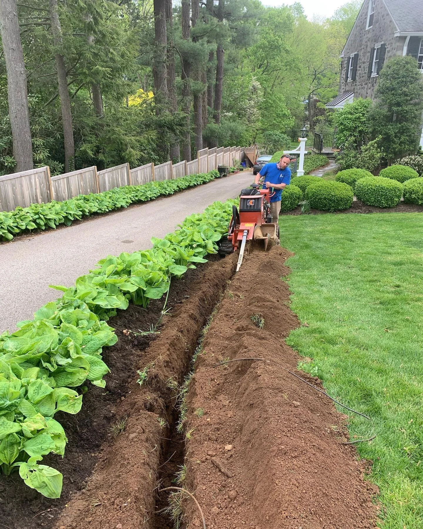 A recent trenching job we completed where we installed a light fixture and receptacle at the top of a drive way.